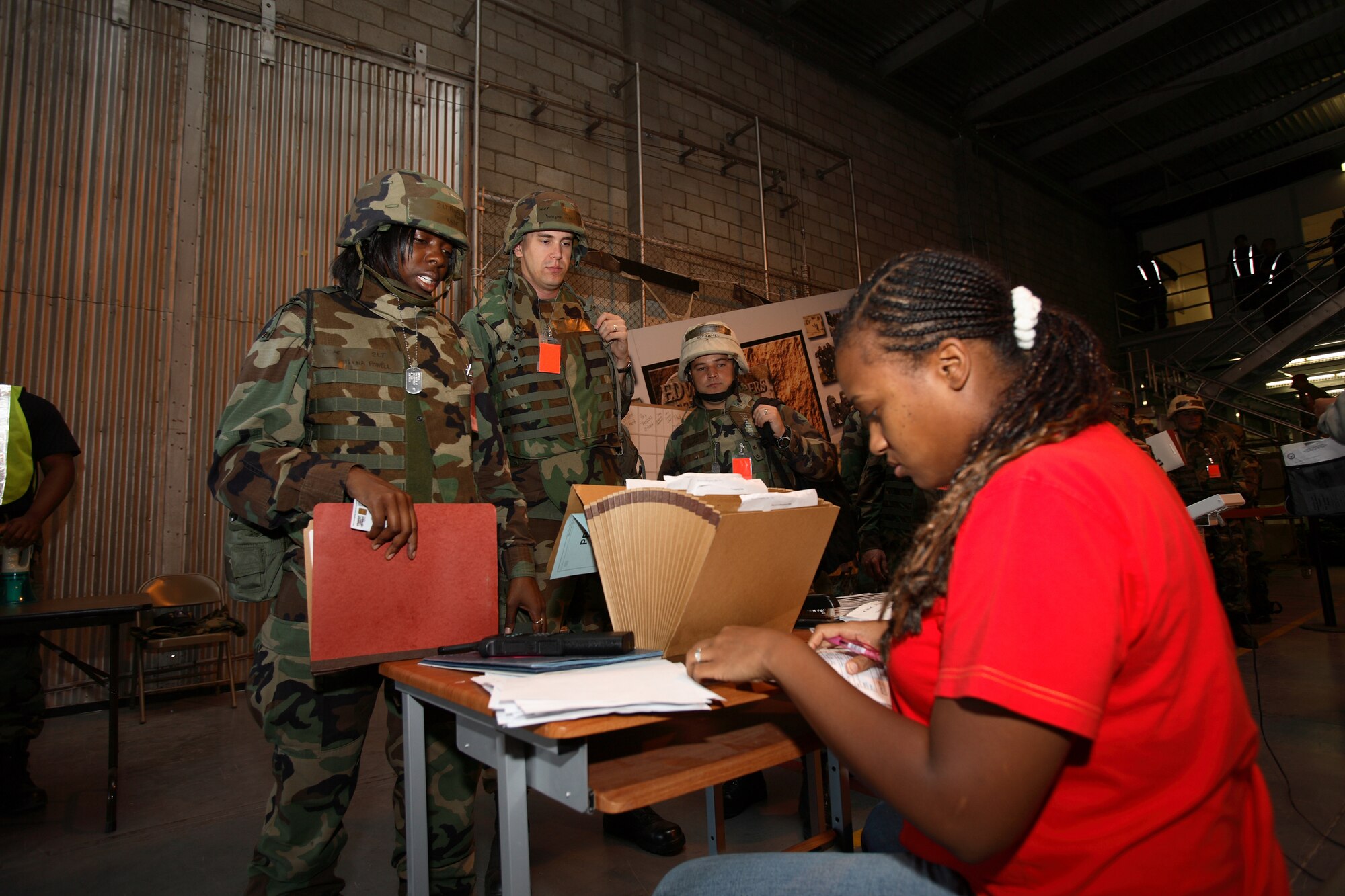A base readiness manager checks the deployers' folders during the Phase I exercise here July 19. The exercise was in preparation for the Air Force Materiel Command Inspector General Phase I re-look, which starts Monday. (Photo by Jet Fabara)
