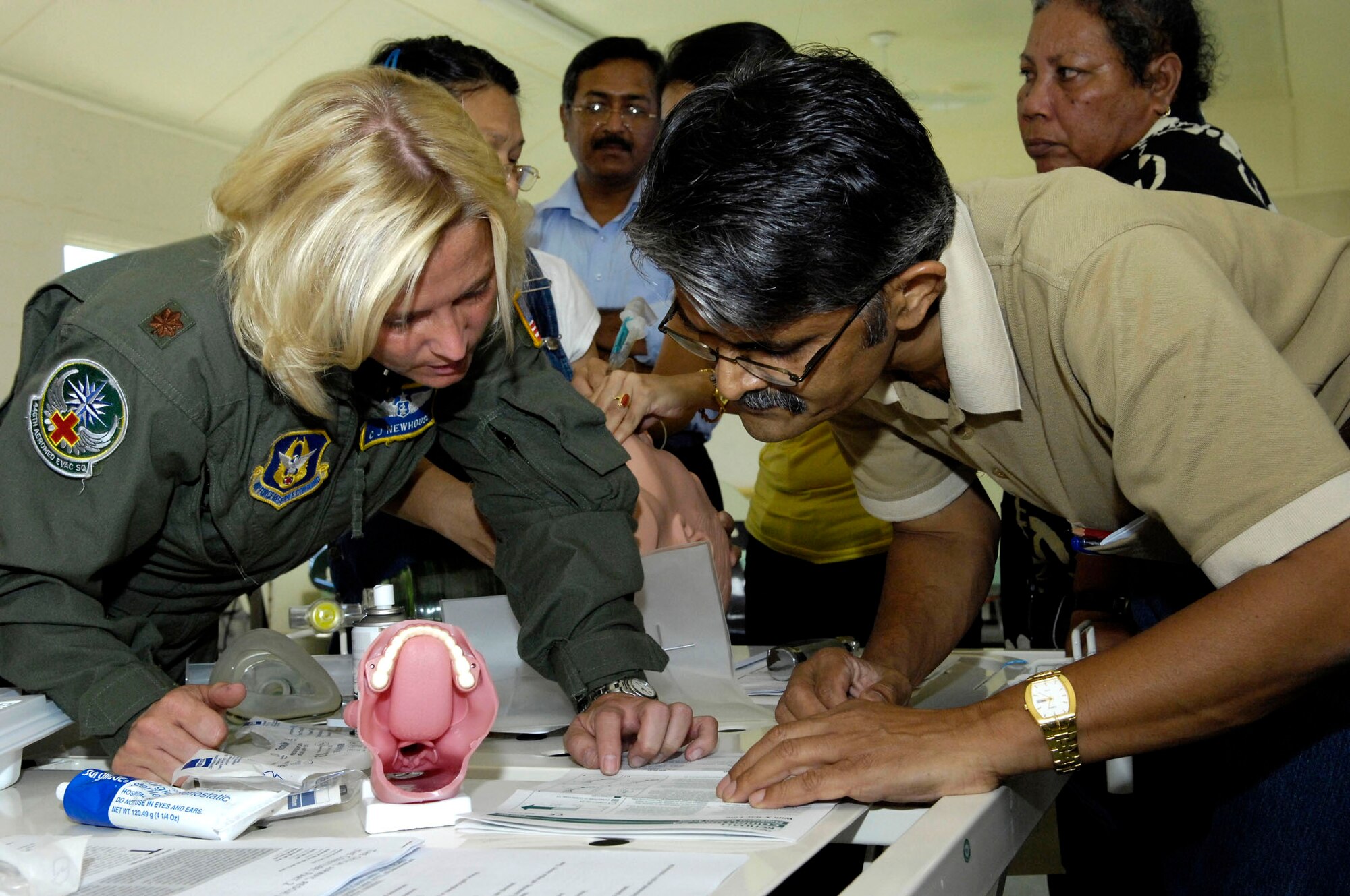 Maj. C.J. Newhouse and Dr. Shakar Ramany look at training materials during an airway management training session July 21 in the Republic of Nauru. Major Newhouse, an Air Force Reserve flight nurse with the 446th Aeromedical Evacuation Squadron, is part of a 12-person, joint-force Pacific Command medical team visiting Nauru, a small island in the South Pacific, from July 21 through 28. Dr. Raman is the director of Health Services at the Republic of Nauru Hospital. (U.S. Air Force photo/Tech. Sgt. Chris Vadnais)
