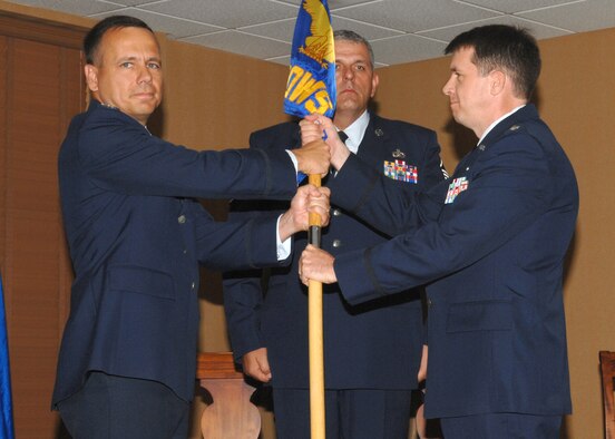 Lt. Col. Donald G. Shannon receives the 25th Operational Weather Squadron guidon from Col.Thomas B. Frooninckx during a change-of-command ceremony held at the Mirage Officers’ Club here on July 17. Colonel Shannon was previously the deputy chief of the Operations Weather Division of the Air, Space and Information Operations Directorate, Headquarters Air Force Special Operations Command.  (U.S. Air Force photo/Airman 1st Class Alesia Goosic)