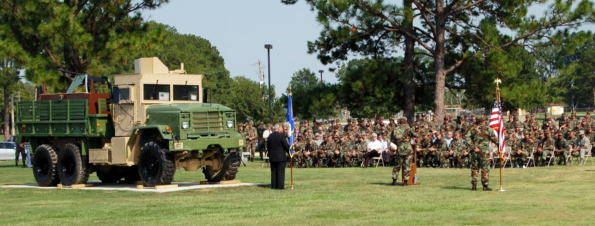 Chief Master Sgt. Malcolm "Mac" McVicar (at the podium), director of the U.S. Air Force Enlisted Heritage Hall Research Institute, addresses distinguished guests and attendees of the Senior Enlisted Leader Summit during an Air Force Convoy Gun Truck Dedication July 23 at the museum.  (U.S. Air Force photo/Master Sgt. Lee Roberts)