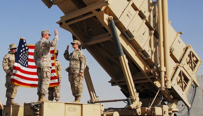 SOUTHWEST ASIA -- Maj. Robert Hartmann, 379th Air Expeditionary Wing, administers the oath of enlistment to Tech. Sgt. Donna Fuccio, 379th Expeditionary Maintenance Group, during her reenlistment ceremony at an Army Patriot missile launcher July 16 at a base in Southwest Asia.

“I was learning the oath of enlistment without breaks,” said the 15-year veteran from Whiteman Air Force Base, Mo. “The meaning of the oath began to sink in that I was supporting and defending the Constitution, so I wanted to have my reenlistment ceremony somewhere that brought that meaning to true light. That is what the Patriot batteries do. They support and defend the base and me too.”  (U.S. Air Force photo/Tech. Sgt. Scott Moorman)