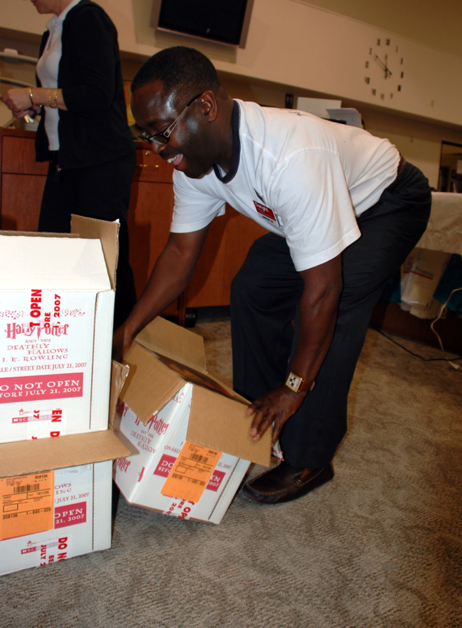 Dwight Marcus, a general manager with the Army Air Force Exchange Service, opens cases of the seventh Harry Potter book moments before they are allowed to be sold at the Sheppard Library's Harry Potter release event July 20. (U.S. Air Force photo/Airman 1st Class Jacob Corbin)