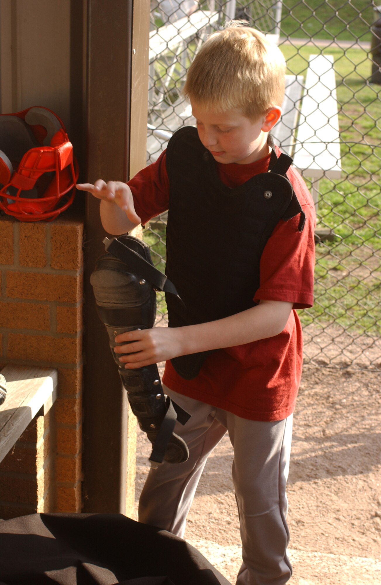 Carl Anthony, son of Brenda and Master Sgt. David Anthony, RAF Lakenheath, dons catchers gear during a T-ball game between the Rattlers and Sand Nats July 3. Carl is one of more than 250 children who participate in Youth Sports T-ball program. (U.S. Air Force photo by Airman 1st Class Kristopher Levasseur.)