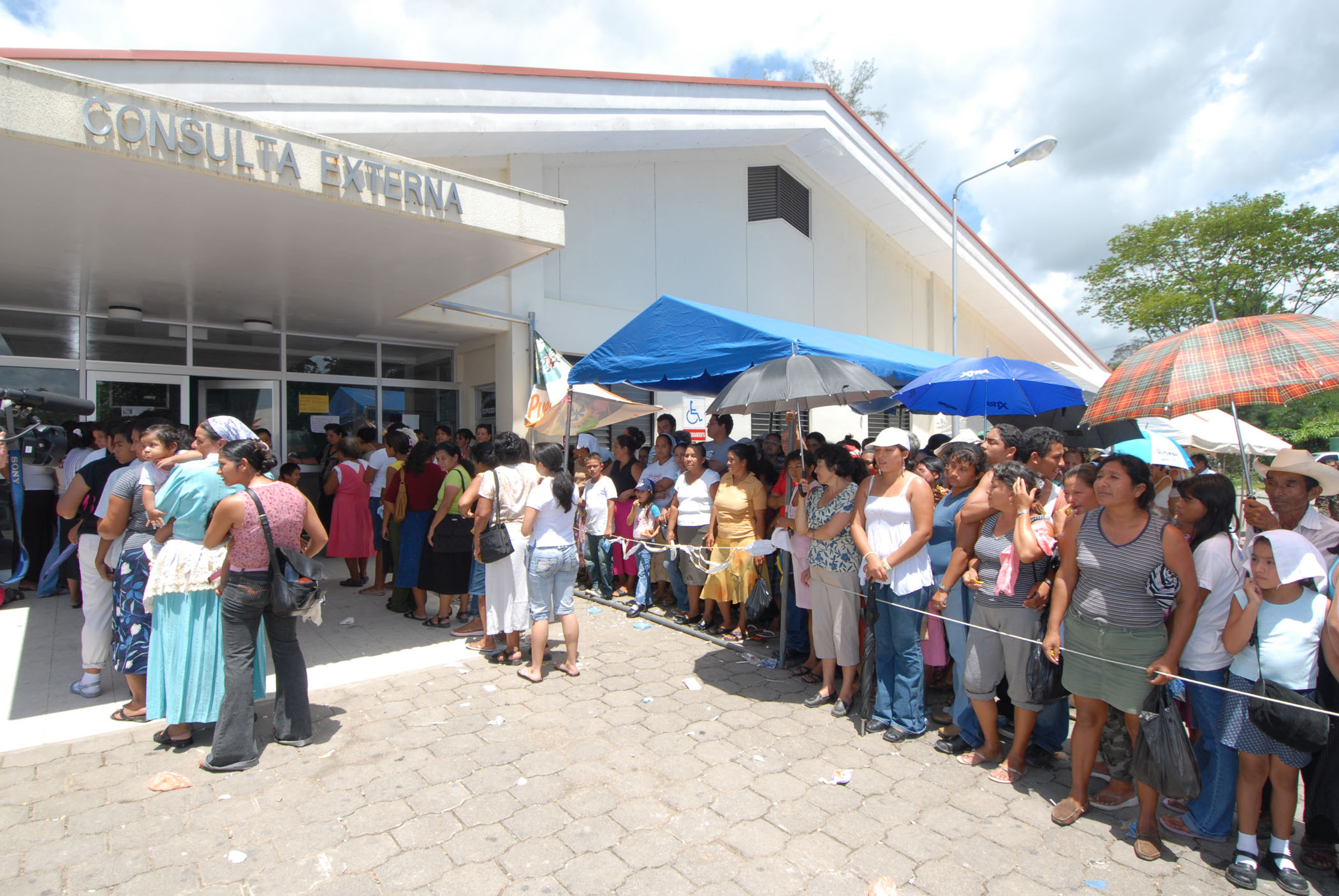 Patients await medical care outside a hospital in Puerto Barrios ...