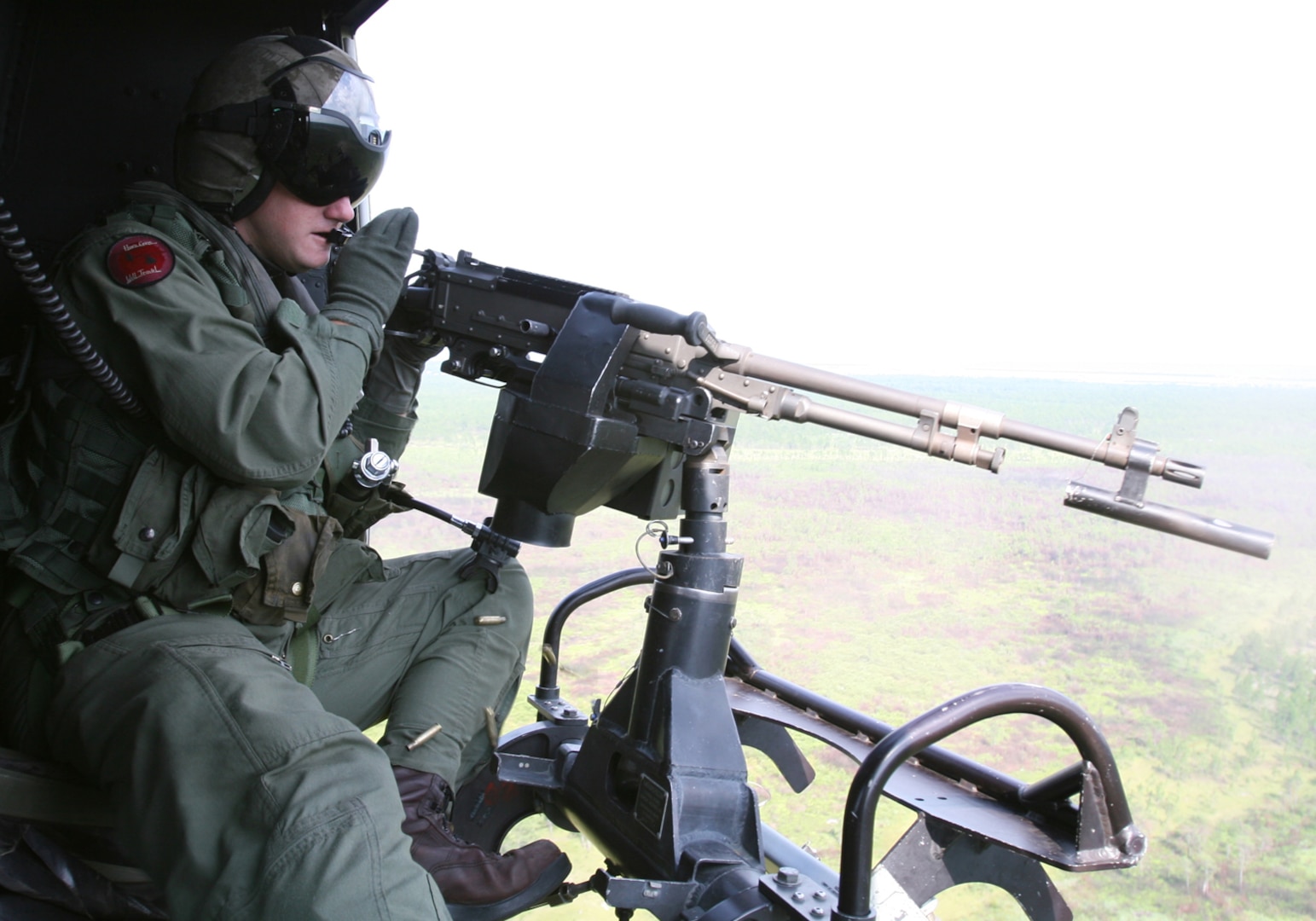 Sgt. Addison C. Hall, Marine Light- Attack Helicopter Squadron 167 crew chief, shoots an M240 D machine gun mounted to a UH-1N Huey during a close air support mission involving 18 aircraft, July 24.  The massive CAS was the largest operation of its kind for the "Warriors."