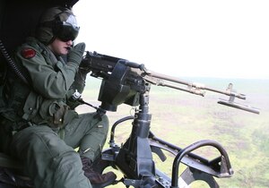 Sgt. Addison C. Hall, Marine Light- Attack Helicopter Squadron 167 crew chief, shoots an M240 D machine gun mounted to a UH-1N Huey during a close air support mission involving 18 aircraft, July 24.  The massive CAS was the largest operation of its kind for the "Warriors."