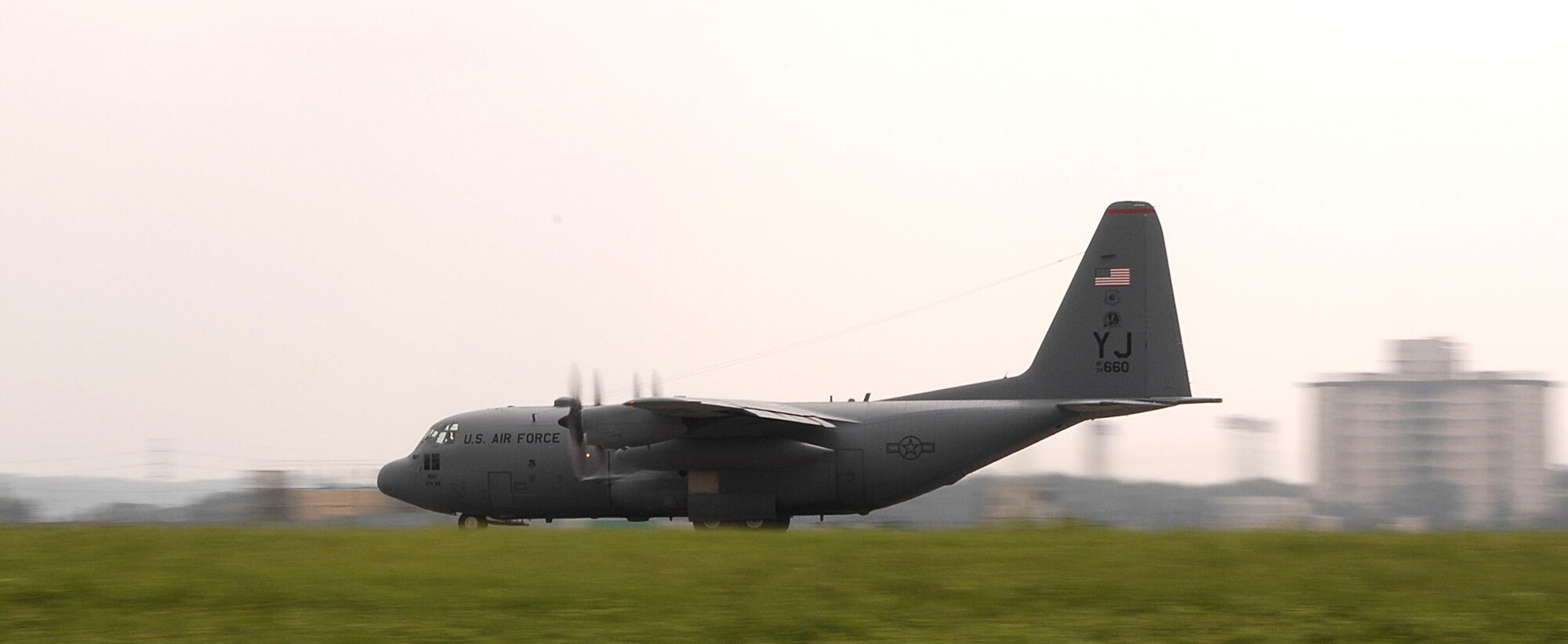 A C-130 Hercules assigned to the 36th Airlift Squadron, takes off after recieving not one, but two black letter initials prior to take off, July 20 and 21, thanks to the Airmen of the 374th Aircraft Maintenance Squadron (AMXS) and the aircraft depot yard in Singapore.(U.S. Air Force Photo by A1C Laszlo Babocsi)(Released)