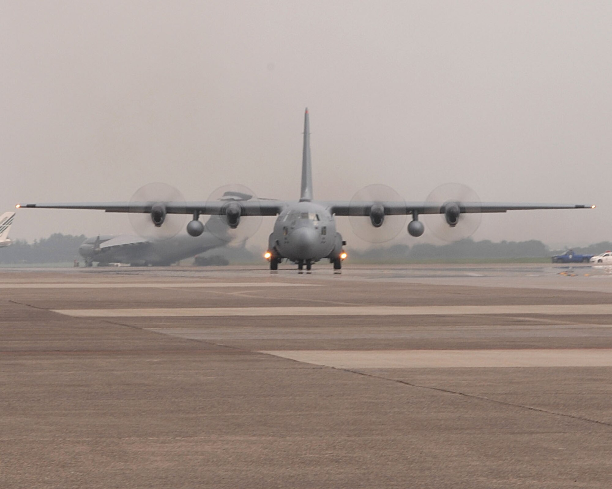 A C-130 Hercules assigned to the 36th Airlift Squadron taxis for take off after recieving not one, but two black letter initials prior to take off, July 20 and 21, thanks to the Airmen of the 374th Aircraft Maintenance Squadron (AMXS) and the aircraft depot yard in Singapore.(U.S. Air Force Photo by A1C Laszlo Babocsi)(Released)