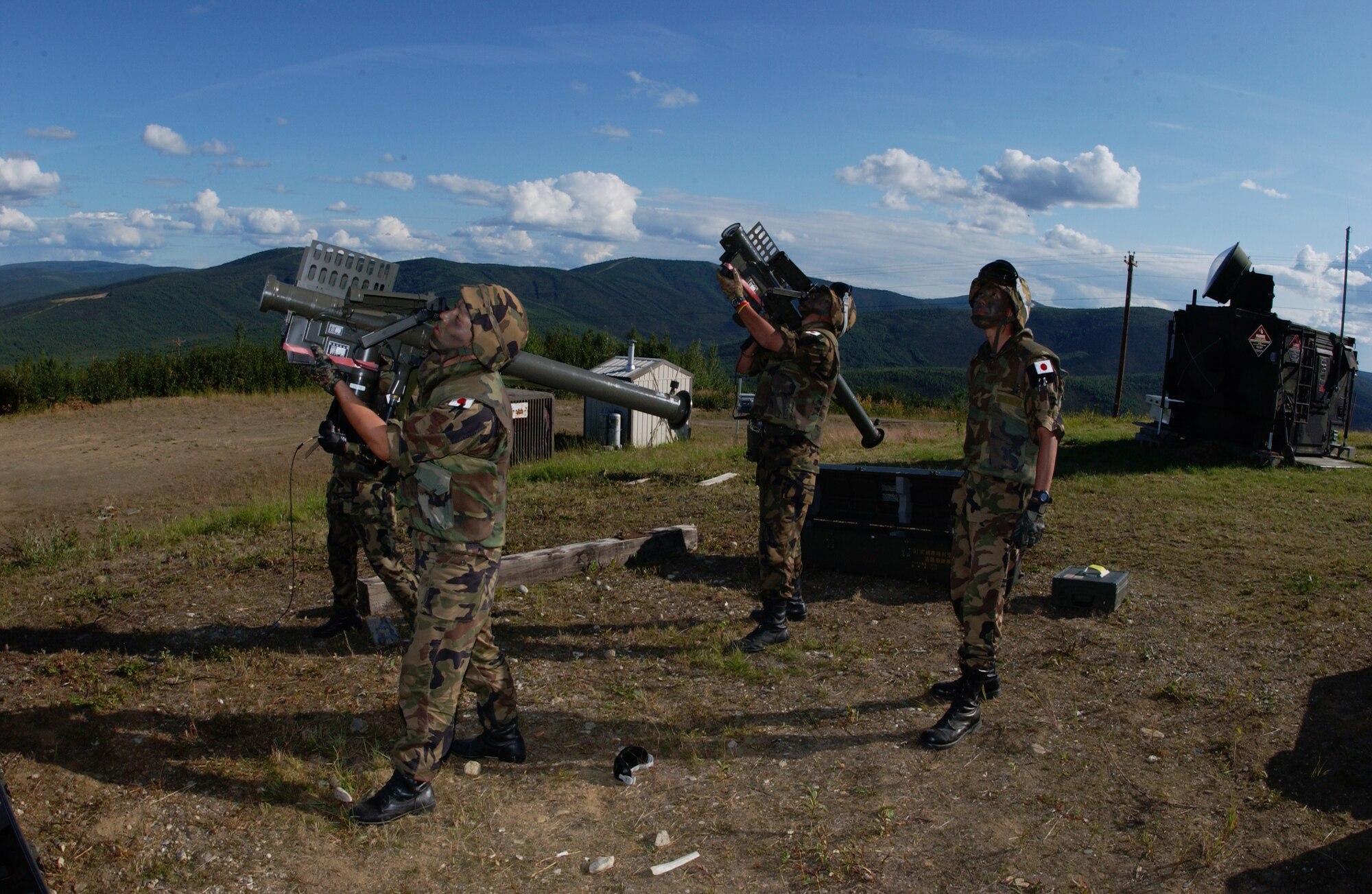 EIELSON AIR FORCE BASE, Alaska -- Staff Sgt. Kenichira Watanabe (Middle) and Staff Sgt. Tomokazu Zmae (Left), missile operator, Japanese Air Self Defense Force, aims a Type 91 Sam-2 Surface to Air missile launcher at enemy aircraft while Staff Sgt. Kensuke Hamanishi (Right), missile operator, Japanese Air Self Defense Force watches for enemy aircraft on the Pacific Alaskan Range Complex on July 24 during Red Flag-Alaska 07-3. With 67,000 square miles of rugged terrain, Japanese Forces are able to train tracking low flying aircrafts against a mountain back drop; this type of training is unavailable to them at their home station. (U.S. Air Force Photo by Airman 1st Class Jonathan Snyder)
