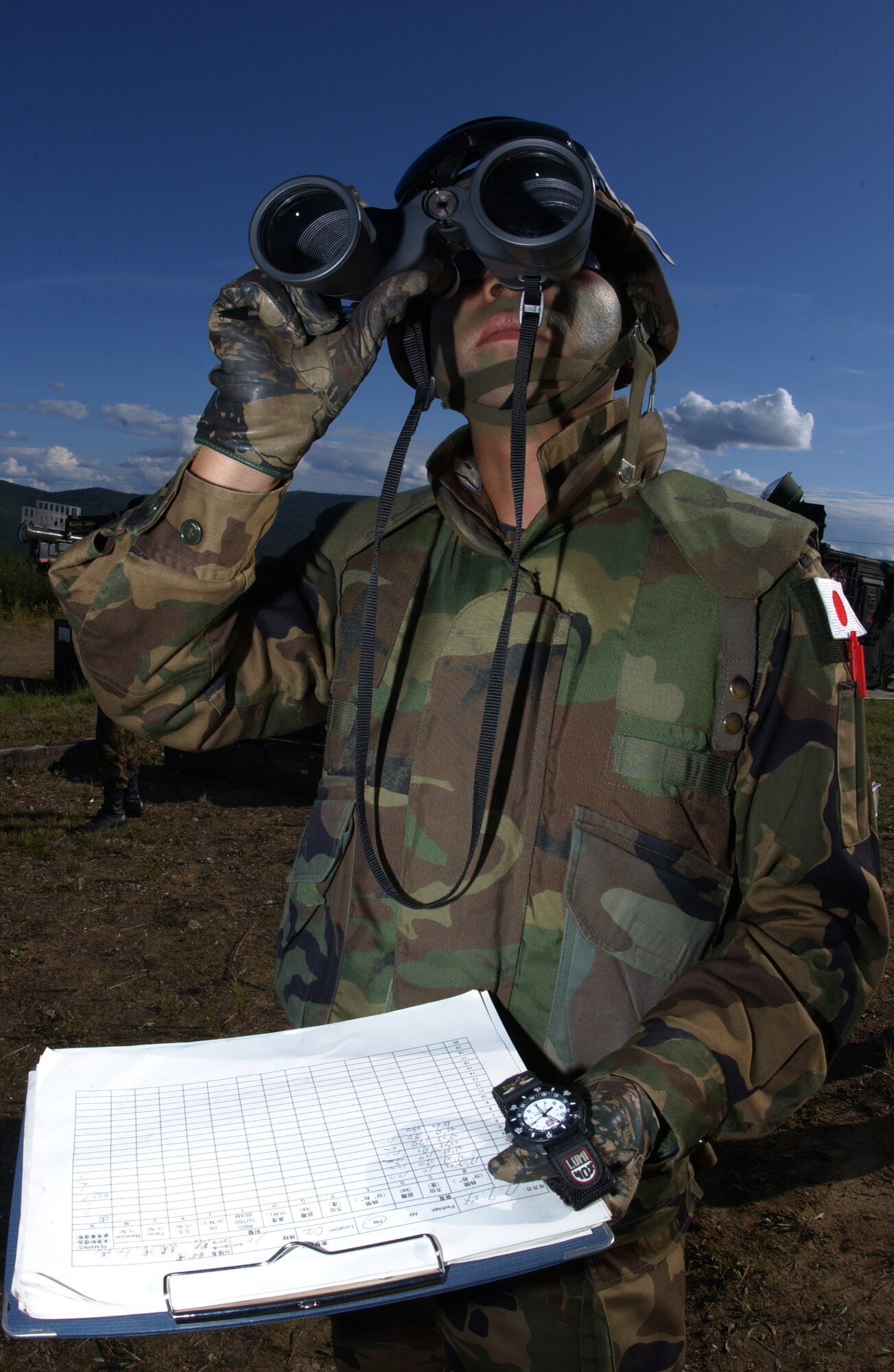 EIELSON AIR FORCE BASE, Alaska -- Staff Sgt. Keiichire Tsunekado, missile operator, Japanese Air Self Defense Force, scouts for incoming enemy aircraft on the Pacific Alaskan Range Complex on July 24 during Red Flag-Alaska 07-3. With 67,000 square miles of rugged terrain, Japanese Forces are able to train tracking low flying aircrafts against a mountain back drop; this type of training is unavailable to them at their home station. (U.S. Air Force Photo by Airman 1st Class Jonathan Snyder)