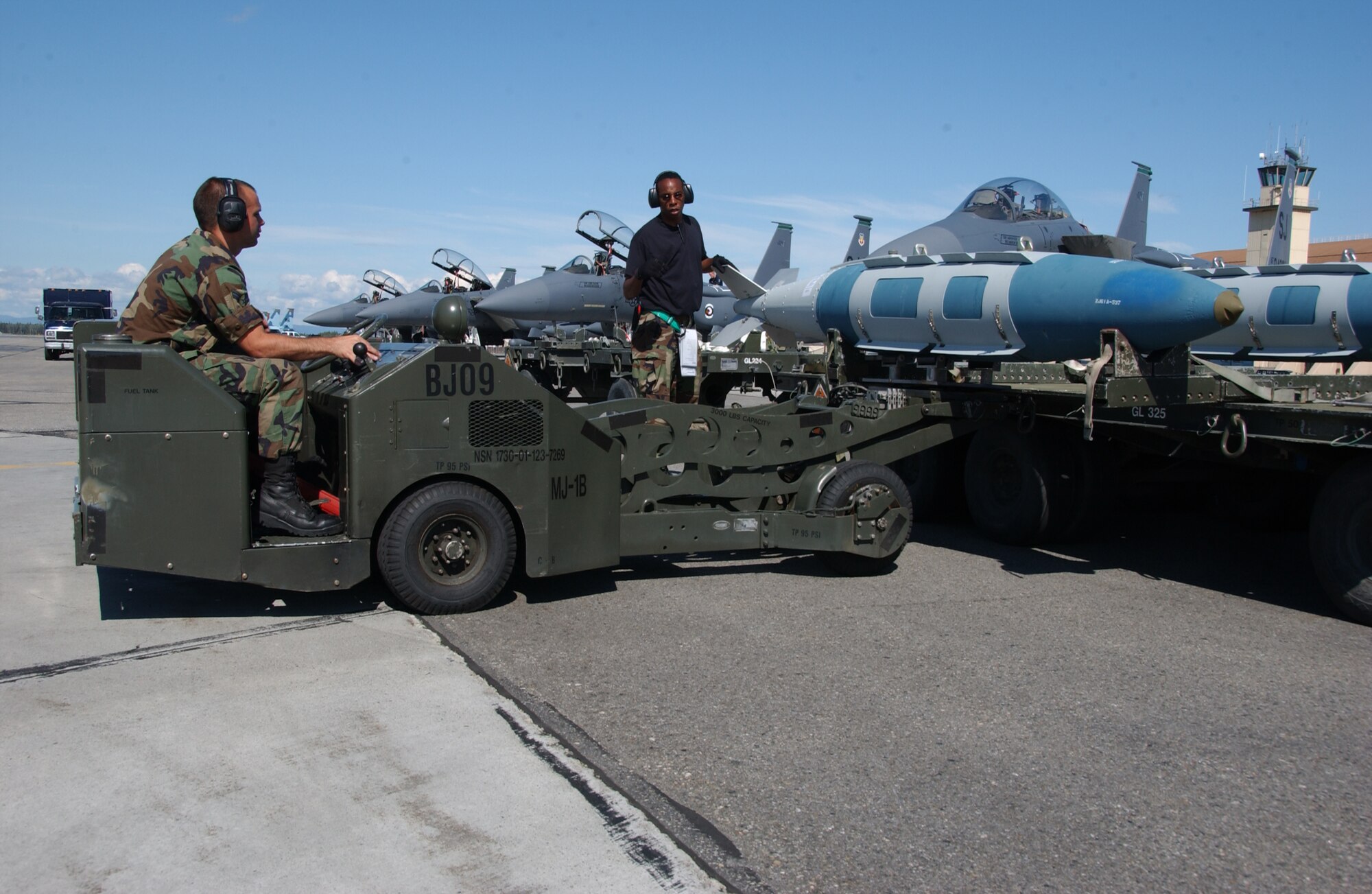 EIELSON AIR FORCE BASE, Alaska -- Staff Sgt. Ray Saunders (Right), Airman 1st Class Scott Perish (Left), weapons armament system specialists, 4th Aircraft Maintenance Squadron, Seymour Johnson Air Force Base, N.C., prepares to transport a GBU-31 bomb onto an F-15 Strike Eagle, 335th Fighter Squadron, Seymour Johnson Air Force Base, in front of the Thunderdome on July 24 during Red Flag-Alaska 07-3. This exercise provides a real-world training environment for maintenance and support personnel through the duration of RF-A. (U.S. Air Force Photo by Airman 1st Class Jonathan Snyder)