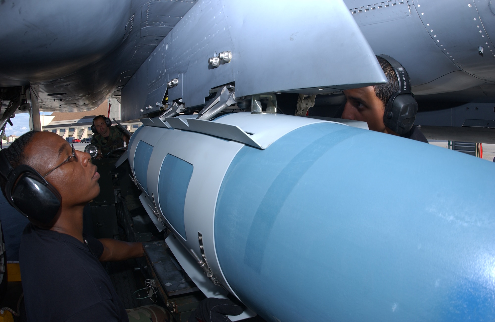 EIELSON AIR FORCE BASE, Alaska -- Staff Sgt. Ray Saunders (Left), Airman 1st Class Santiago Mosquera (Right), and Airman 1st Class Scott Perish (Back), weapons armament system specialists, 4th Aircraft Maintenance Squadron, Seymour Johnson Air Force Base, N.C., loads a GBU-31 bomb onto an F-15 Strike Eagle, 335th Fighter Squadron, Seymour Johnson Air Force Base, in front of the Thunderdome on July 24 during Red Flag-Alaska 07-3. This exercise provides a real-world training environment for maintenance and support personnel through the duration of RF-A. (U.S. Air Force Photo by Airman 1st Class Jonathan Snyder)