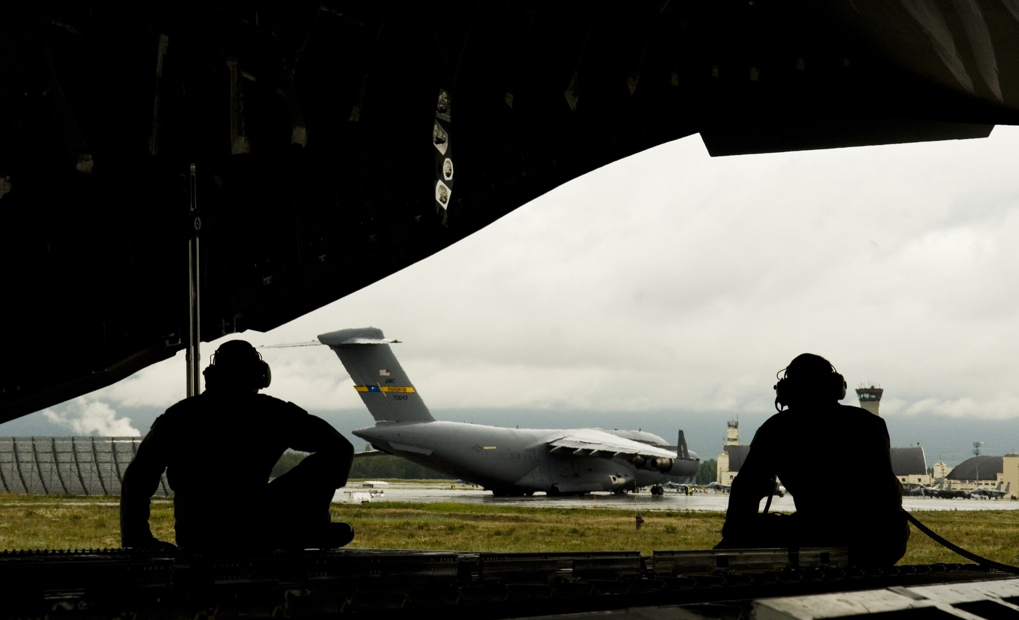 ELEMDORF AIR FORCE BASE, Alaska -- Staff Sgt. Justin Mulder (right), 517th Airlift Squadron here, and Senior Airman Keith Roscoe, 535th AS, Hickam Air Force Base, Hawaii, sit in the back of the C-17 "Spirit of Denali" as the aircraft taxis following a RED FLAG-Alaska training sortie July 24. (U.S. Air Force Photo by Senior Airman Garrett Hothan)