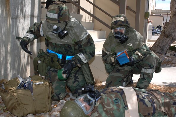 Staff Sgt. Phillip Farrior and Tech. Sgt. Jamie Boyer carry out a post-attack-reconaissance-sweep measures during an operational readiness exercise July 17. OREs help keep Airmen familiar with procedures they will need to know in a deployed environment. (U.S. Air Force photo by Alex R. Lloyd)