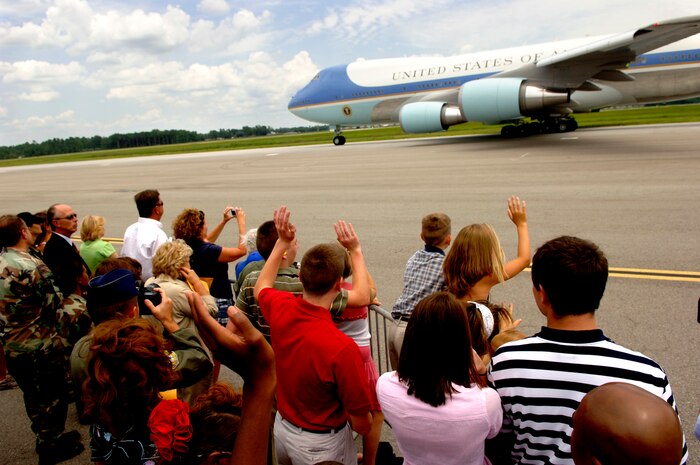 A crowd of Air Force Airmen and family members wave to Air Force One as it leaves the Charleston flightline Tuesday. (U.S. Air Force Photo/Airman 1st Class Nicholas Pilch)