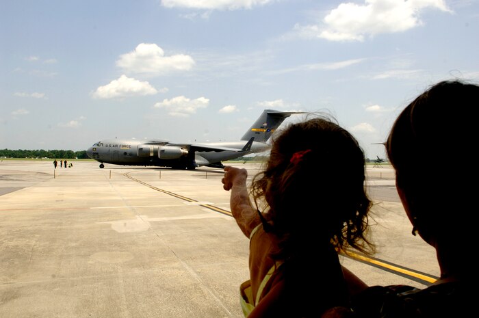 Stacey and Olivia Boone, family members of Staff Sgt. Scott Boone, 315th Security Forces Squadron installation patrolman, wave to the 2007 AMC Rodeo Team aboard a C-17 Thursday  before taking off to McCord AFB, Wash. (U.S. Air Force photo/Airman 1st Class Nicholas Pilch) 