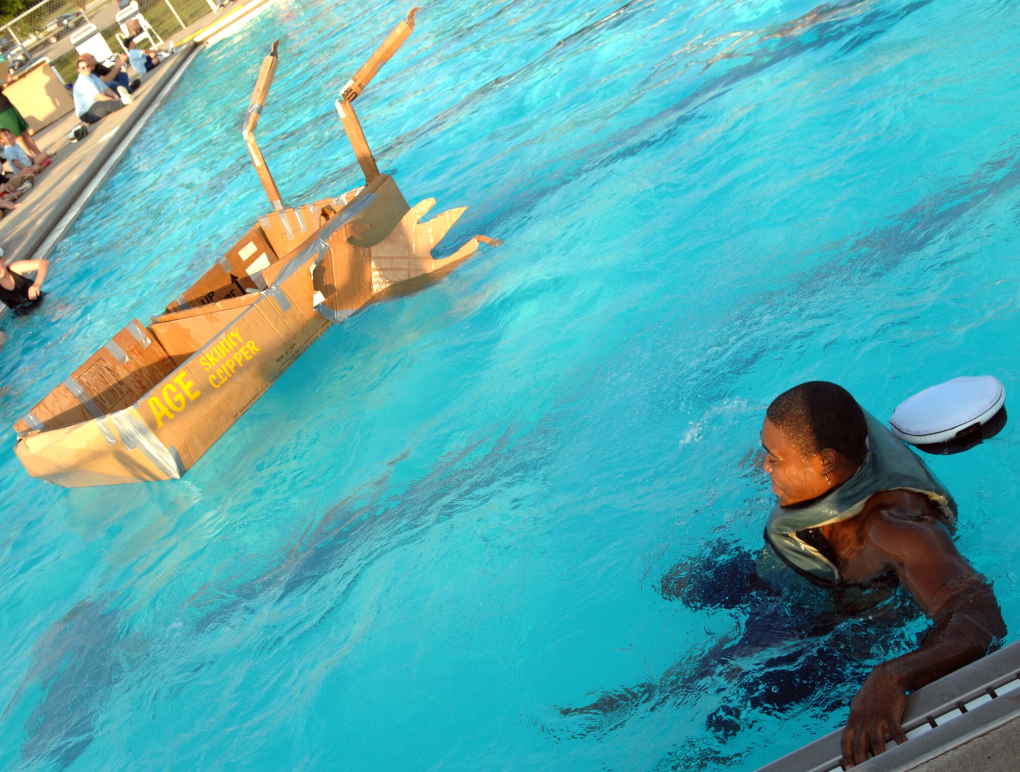 WHITEMAN AIR FORCE BASE, Mo -- Airman 1st Class Quintellis Darden, 509th Maintenance Squadron, the captain of the S.S. Skinny Clipper, looks on as his ship drifts away in the base pool July 20 during the Build-a-Boat contest. For other 509th Services Squadron events, visit http://www.whitemanservices.com/ (U.S. Air Force photo/Airman 1st Class Stephen Linch)