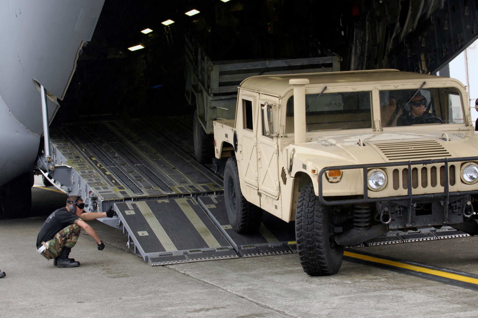 Airmen from the 315th Airlft Wing, Air Force Reserve Unit, Charleston Air Force Base, S.C., load A U.S. Air Force C-17 Globemaster III during the Aerial Ports Engine Running On Loads Competition for Air Mobility Rodeo 2007. Rodeo 2007 is a readiness competition of U.S. and international mobility air forces. It focuses on improving warfighting capabilities and support of the Global War on Terrorism.  (U.S. Air Force Photo/Airman 1st Class Nichelle Griffiths) 
