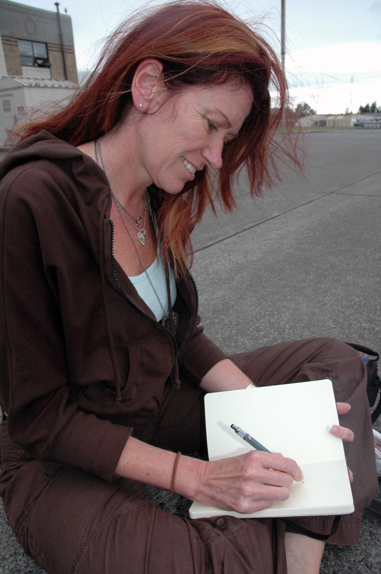 Ms. Christine Murphy Soucey, an artist from Haverhill, Mass., who is a member of the Air Force Art Program, sketches a KC-10 Extender from McGuire Air Force Base, N.J., during operations for Air Mobility Rodeo 2007 at McChord AFB, Wash., July 23.  Ms. Soucey, who signs here artwork with "Murphy," has been an artist for more than 25 years and works in oils and mixed media.  She is one of four artists in the AF Art Program to visit Rodeo for future art works for the Air Force.  (U.S. Air Force Photo/Tech. Sgt. Scott T. Sturkol)