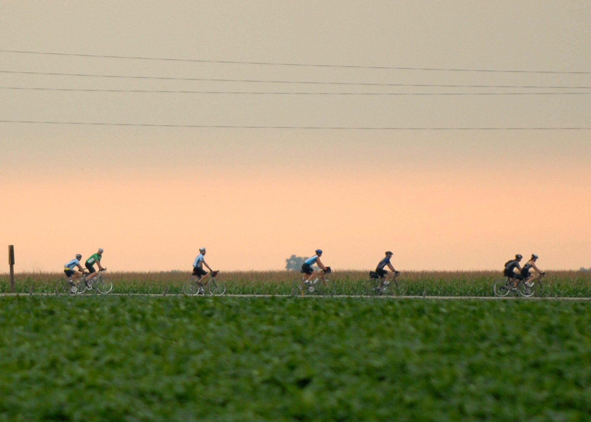 Some of the 148 members of the U.S. Air Force Cycling Team ride across the Iowa countryside from Spencer to Humboldt July 23 during the third day of the Register's Annual Great Bike Ride Across Iowa, known as RAGBRAI, a cycling event sponsored by the Des Moines Register newspaper.  This is the 13th year the Air Force Cycling Team has participated in the RAGBRAI to support Air Force recruiting. (U.S. Air Force photo/Airman 1st Class Joanna M. Kresge)