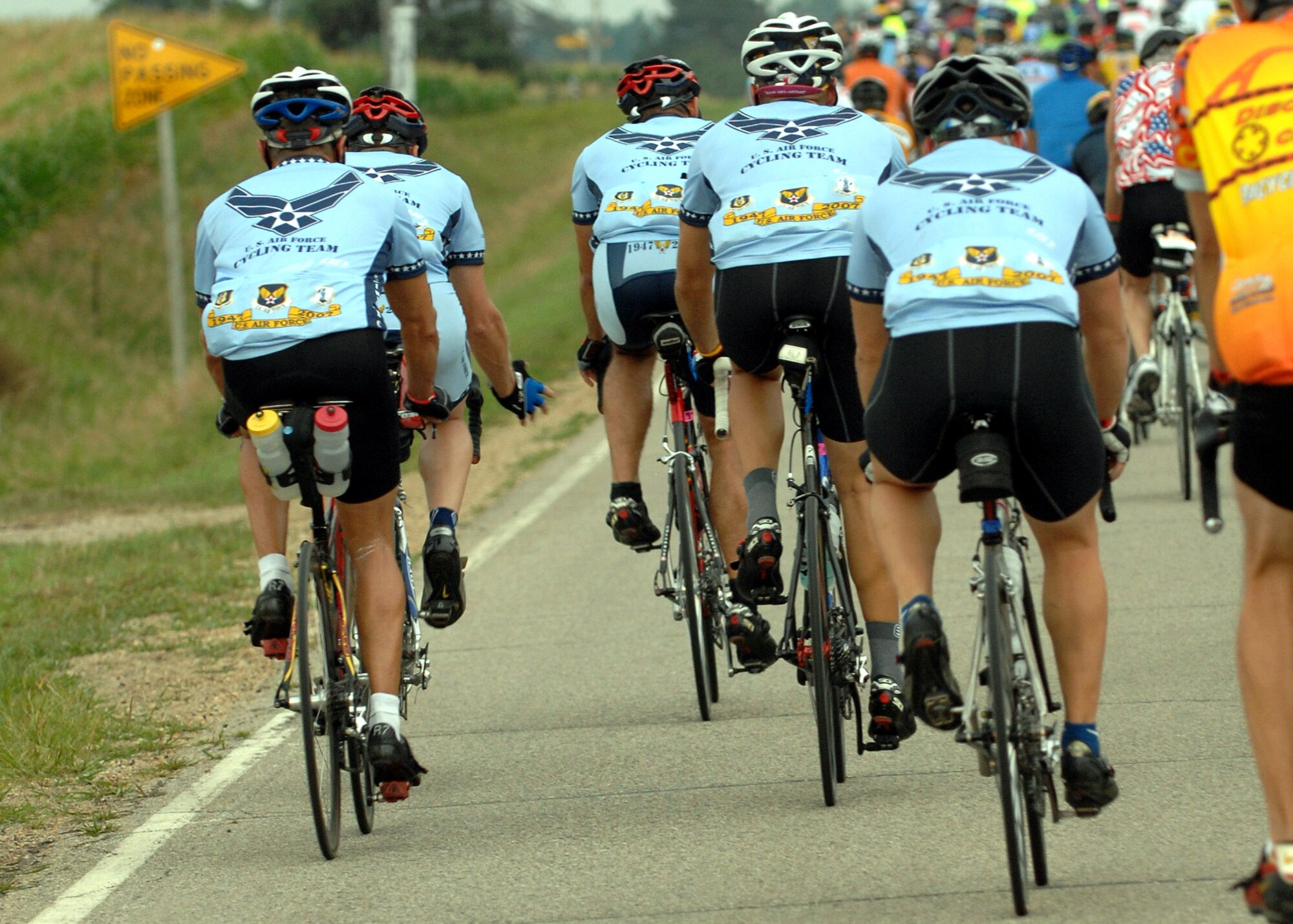 Some of the 148 members of the U.S. Air Force Cycling Team ride across the Iowa countryside from Spencer to Humboldt July 23 during the third day of the Register's Annual Great Bike Ride Across Iowa, known as RAGBRAI, a cycling event sponsored by the Des Moines Register newspaper.  This is the 13th year the Air Force Cycling Team has participated in the RAGBRAI to support Air Force recruiting. (U.S. Air Force photo/Airman 1st Class Joanna M. Kresge)