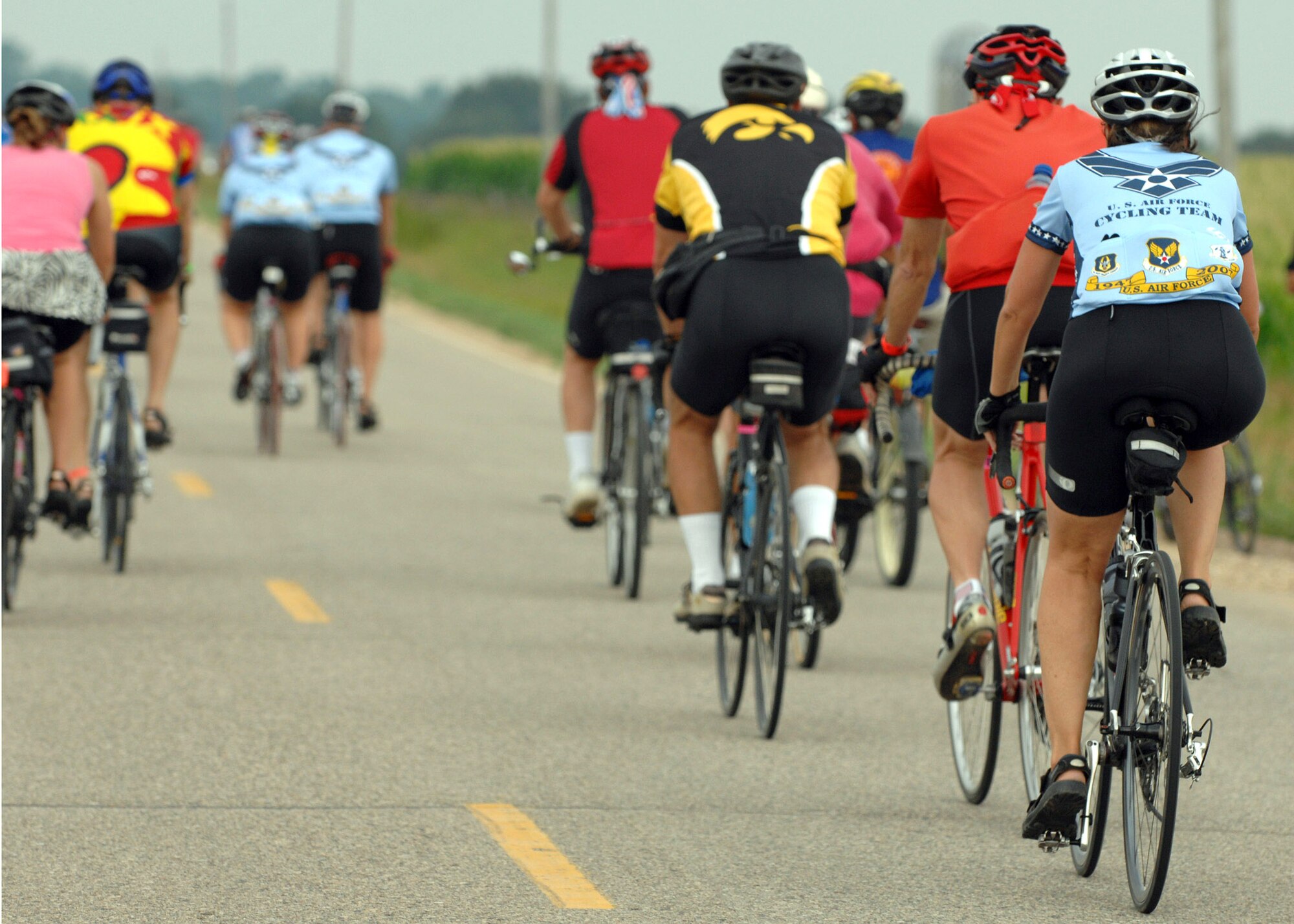 A member of the U.S. Air Force Cycling Team rides her bicycle from Spencer to Humboldt, Iowa, along with other participants July 23 during the third day of the Register's Annual Great Bike Ride Across Iowa, known as RAGBRAI, a cycling event sponsored by the Des Moines Register newspaper.  This is the 13th year the Air Force Cycling Team has participated in the RAGBRAI to support Air Force recruiting. (U.S. Air Force photo/Airman 1st Class Joanna M. Kresge)