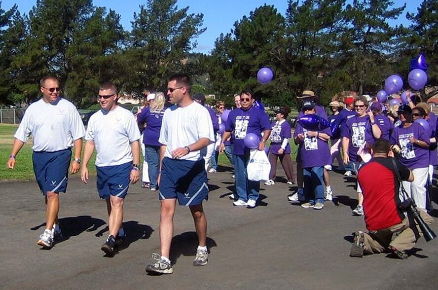 (From left to right) Staff Sgt. Randy Rundio, Staff Sgt. Jeff Gorrell, and Maj. Dan Mangan, take part in “Relay for Life,” July 21. The event is a relay race designed to reflect 24 hours in the life of a cancer patient while raising money for cancer victims. The Airmen are from the 22nd Airlift Squadron. (U.S. Air Force photo)