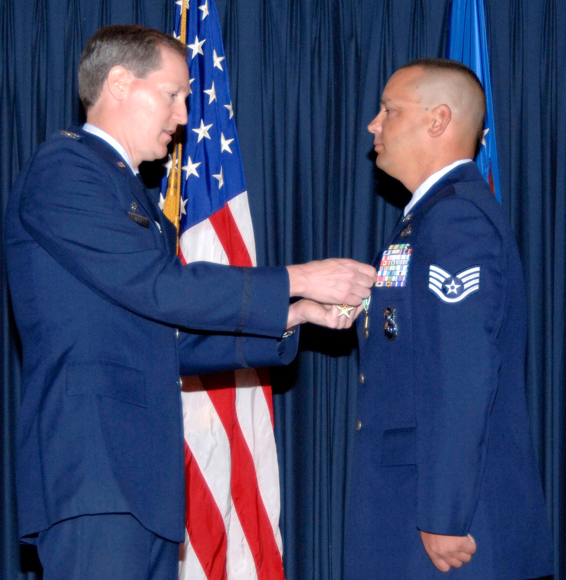 Staff Sgt. Jason Kimberling is awarded a Bronze Star with Valor and an Army Commendation Medal by Col. Thomas Laffey July 19 at Mountain Home Air Force Base, Idaho, for his actions Aug. 8, 2006 in Qalat Province, Afghanistan. Sergeant Kimberling was one of only three Americans in a coalition tasking with the Afghan national police that was attacked. His actions prevented the entire coalition force from being split up during an ambush. Sergeant Kimberling is assigned to the 366th Security Forces Squadron, and Colonel Laffey is the 366th Mission Support Group commander. (U.S. Air Force photo/Airman 1st Class Stephany D. Miller)