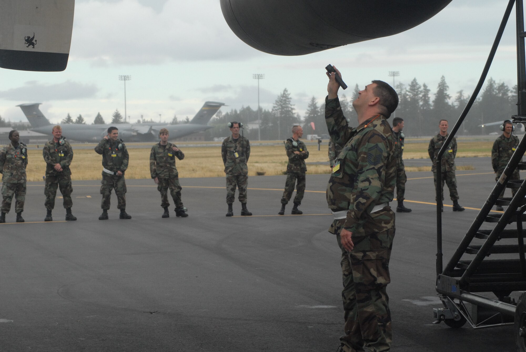 The 2007 Pope Rodeo maintenance team, watch as inspectors evaluate the plane’s condition during a post flight inspection Monday at McChord Air Force Base, Wash. The maintenance team consist of ten personnel from Pope who also competed in preflight inspection and refueling events during the Air Mobility Command Rodeo competition. (U.S. Air Force photo/Staff Sgt. Jon Ladue)