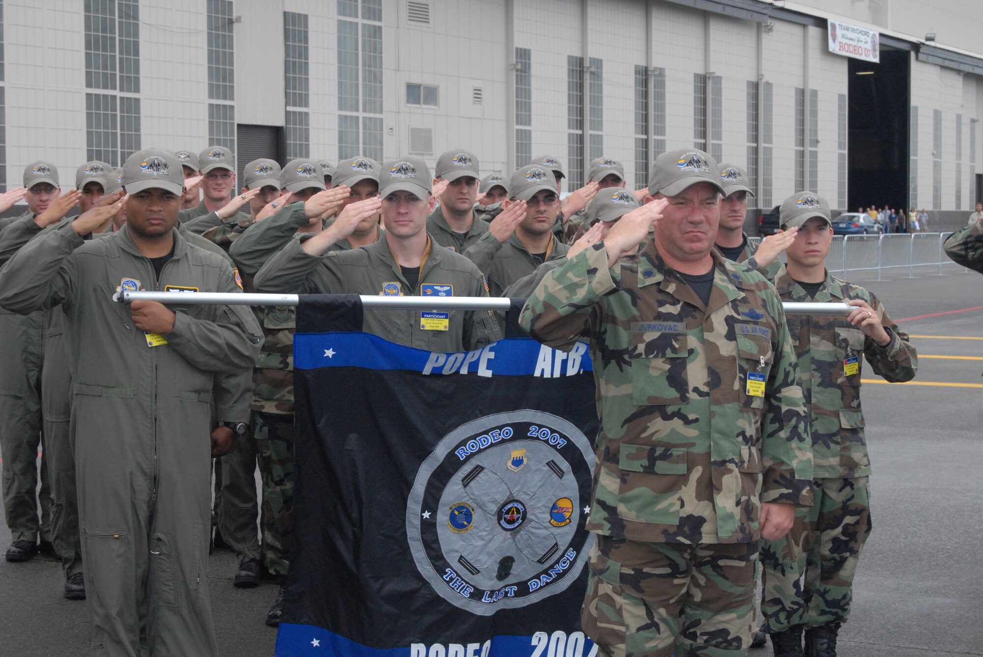 The Pope Rodeo team salutes the flag during the National Anthem Sunday at the 2007 Air Mobility Command Rodeo 2007 opening ceremonies at McChord Air Force Base, Wash. The 35 person team competed in more than 20 events from Saturday through Friday. (U.S. Air Force photo/Staff Sgt. Jon Ladue)