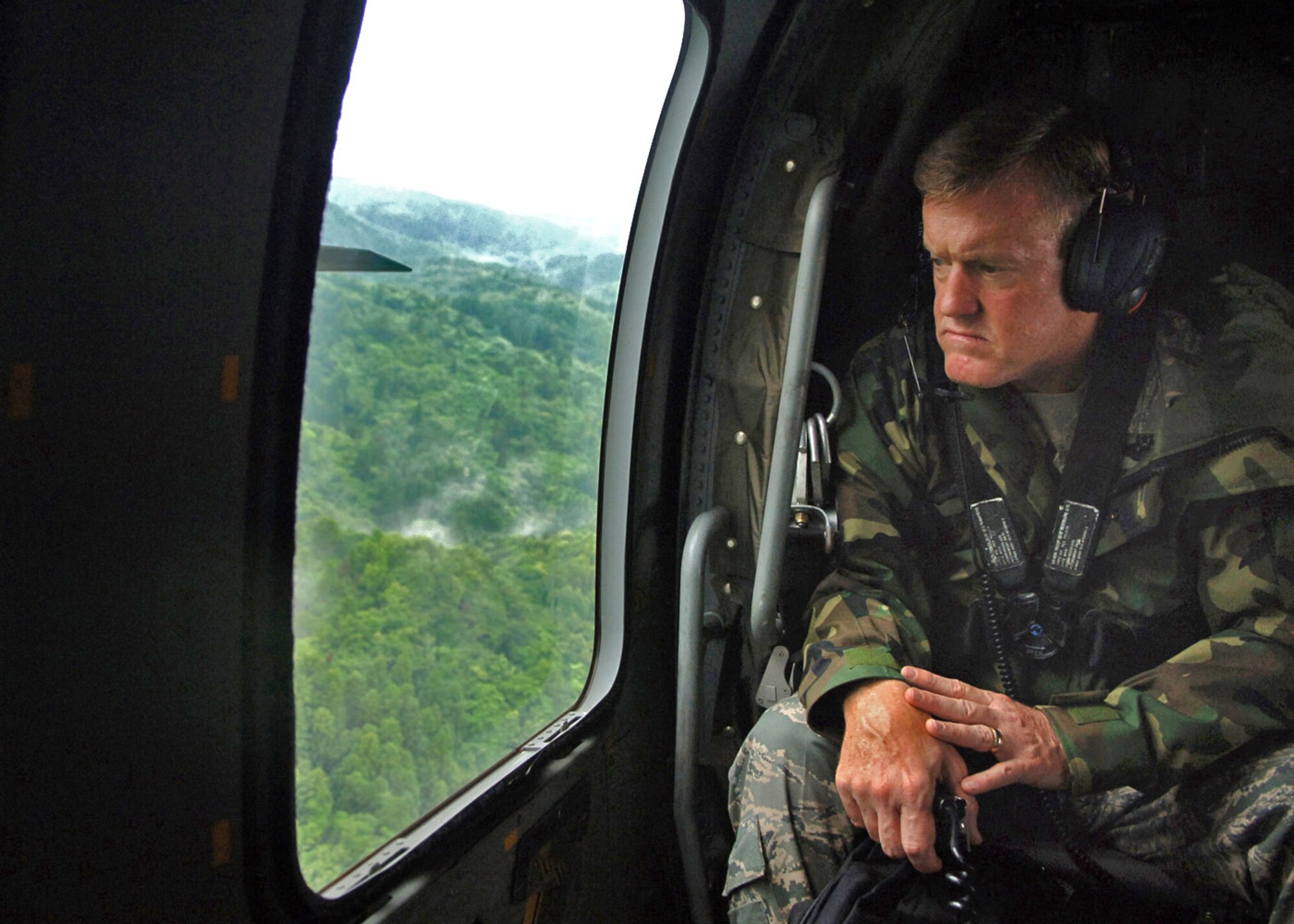 Lt. Gen. Bruce Wright looks out from a Japan Self Defense Force HH-60 Blackhawk helicopter as it flies over areas of Japan damaged by an earthquake July 16. The U.S. Forces Japan commander was visiting military relief teams providing support to citizens affected by the earthquake. (U.S. Air Force photo/Senior Airman Veronica Pierce)