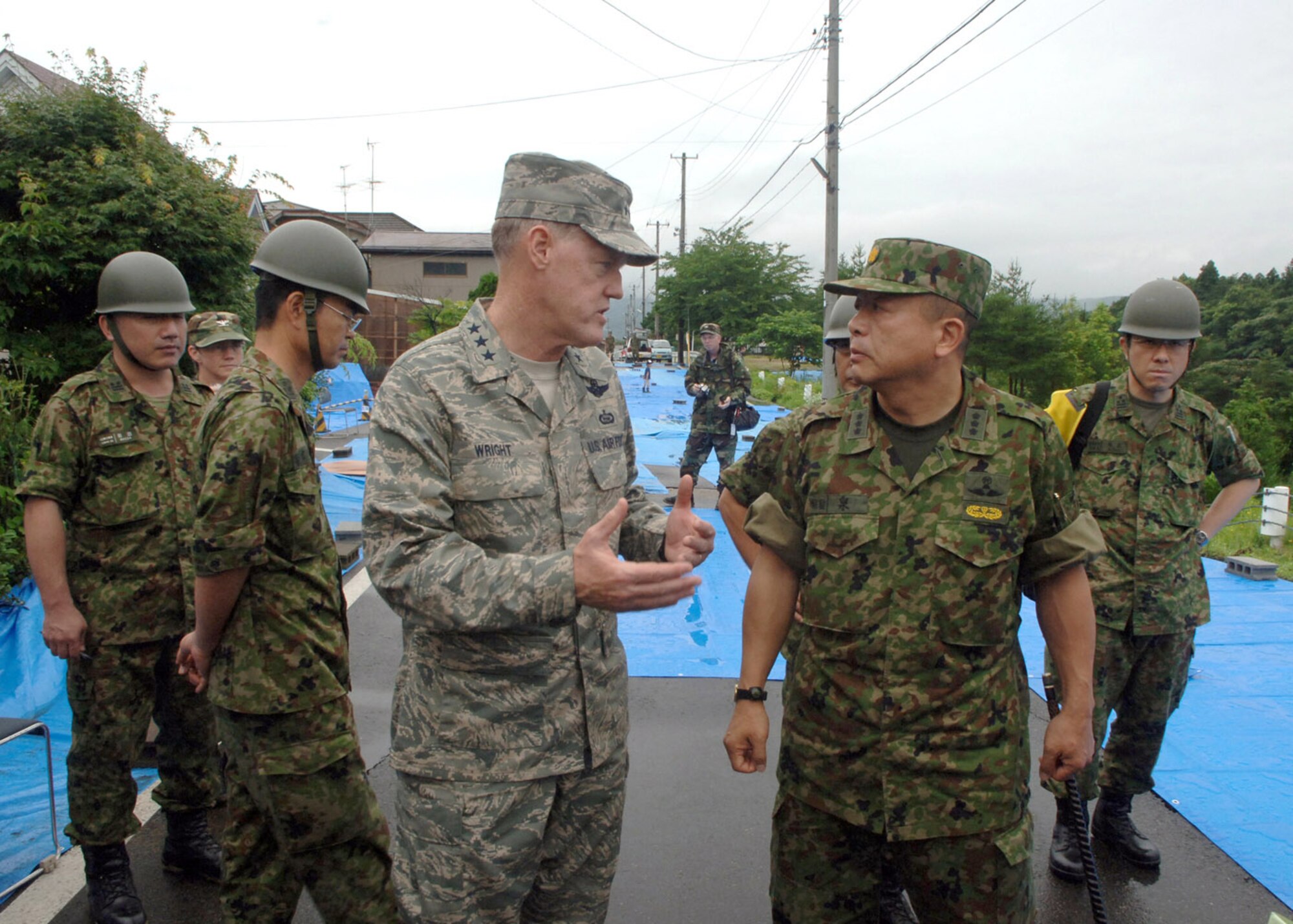 Lt. Gen. Bruce Wright and Lt. Gen. Kazushige Izumi view the damage July 21 caused by an earthquake that hit Niigata Prefecture in Japan on July 16. They were visiting a relief team providing assistance to the citizens affected by the earthquake.  General Wright is U.S. Forces Japan commander and General Izumi is commander of the Japan Eastern Army.  (U.S. Air Force photo/Senior Airman Veronica Pierce) 