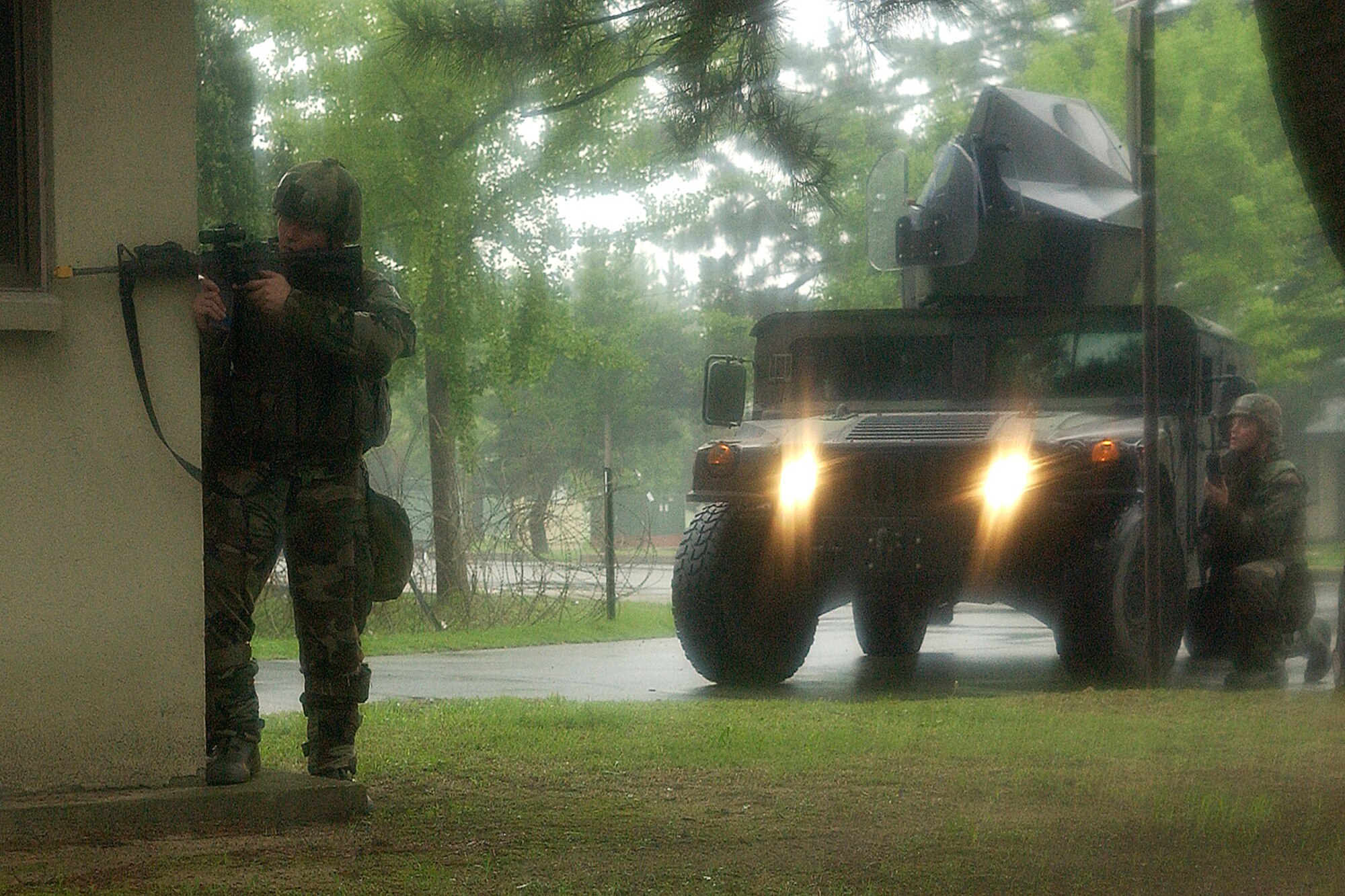 Kunsan Air Base, Republic of Korea -- Airmen 1st Class Michael Seago and Stephen Lawrie from the 8th Security Forces Squadron, engage opposing forces during the Peninsula-Wide Combat Employment Readiness Exercise July 24 here. (U.S. Air Force photo/Senior Airman Giang Nguyen)
                                                                                                