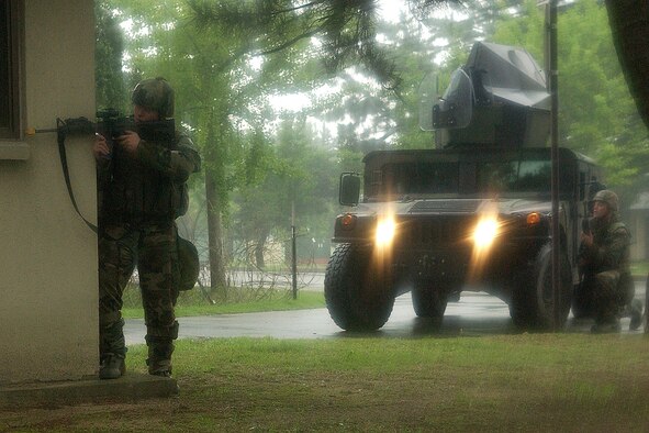 KUNSAN AIR BASE, Republic of Korea -- Airmen 1st Class Michael Seago and Stephen Lawrie, 8th Security Forces Squadron, engage opposing forces during the Peninsula-Wide Combat Employment Readiness Exercise here July 24. (U.S. Air Force photo/Senior Airman Giang Nguyen)