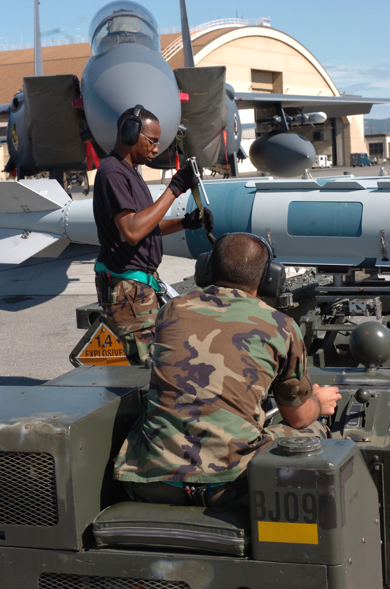 EIELSON AIR FORCE BASE, Alaska -- Staff Sgt. Ray Saunders (left) loosens fastening straps on GBU-31 bomb prior to unloading by Airman 1st Class Scott Parish. Both Airmen, with the 335 Fighter Squadron, are participating with Red Flag  Alaska 07-3, a multinational air combat training exercise. (U.S. Air Force photo by MSgt Brandt Smith)