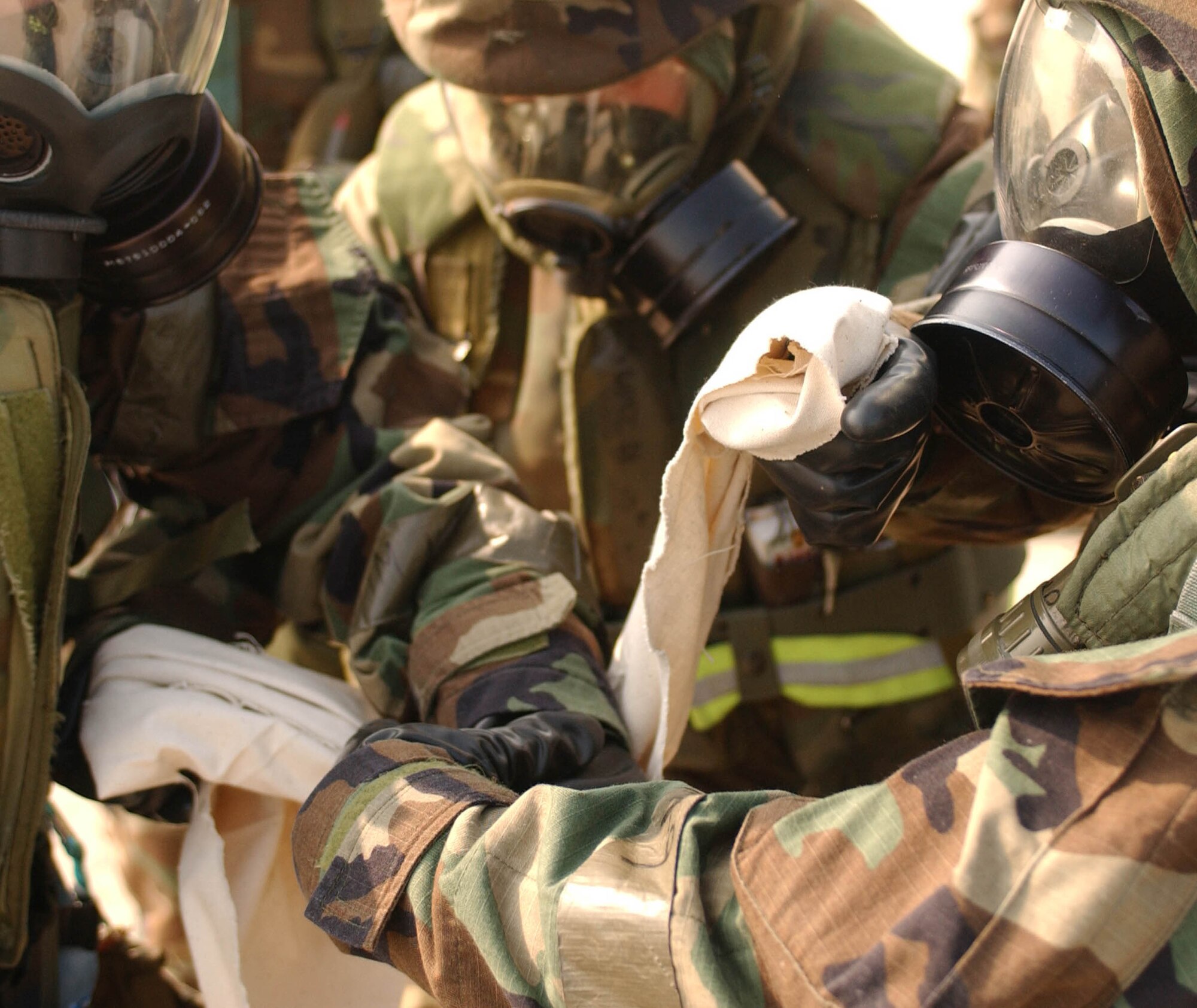 KUNSAN AIR BASE, Republic of Korea --Airmen from the 8th Maintenance Squadron perform self-aid and buddy care to a fellow Airman's arm after she was hurt during a simulated missle attack during the Peninsula-Wide Combat Employment Readiness Exercise July 23 here. (U.S. Air Force photo/Senior Airman Steven R. Doty)                                                                             