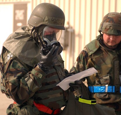 KUNSAN AIR BASE, Republic of Korea -- Tech. Sgt. Michael Rhudy, 555th Fighter Squadron, Aviano Air Base Italy, calls in a report during an evacuation of a facility after a simulated missile attack during the Peninsula-Wide Combat Employment Readiness Exercise here July 25. Sergeant Rhudy is here with the "Triple Nickel" for a four-month deployment. He is working with the 8th Maintenance Squadron. (U.S. Air Force photo/Senior Airman Steven R. Doty)