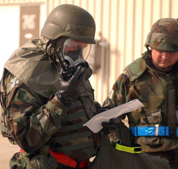 KUNSAN AIR BASE, Republic of Korea --Tech. Sgt. Michael Rhudy, 555th Fighter Squadron, Aviano Air Base Italy, calls in a report during an evacuation of a facility after a simulated missle attack during the Peninsula-Wide Combat Employment Readiness Exercise July 25 here. Sergeant Rhudy is here with the "Triple Nickel" for a four- month deployment.  He is working with the 8th Maintenance Squadron. (U.S. Air Force photo/SeniorAirman Steven R. Doty)                                                                