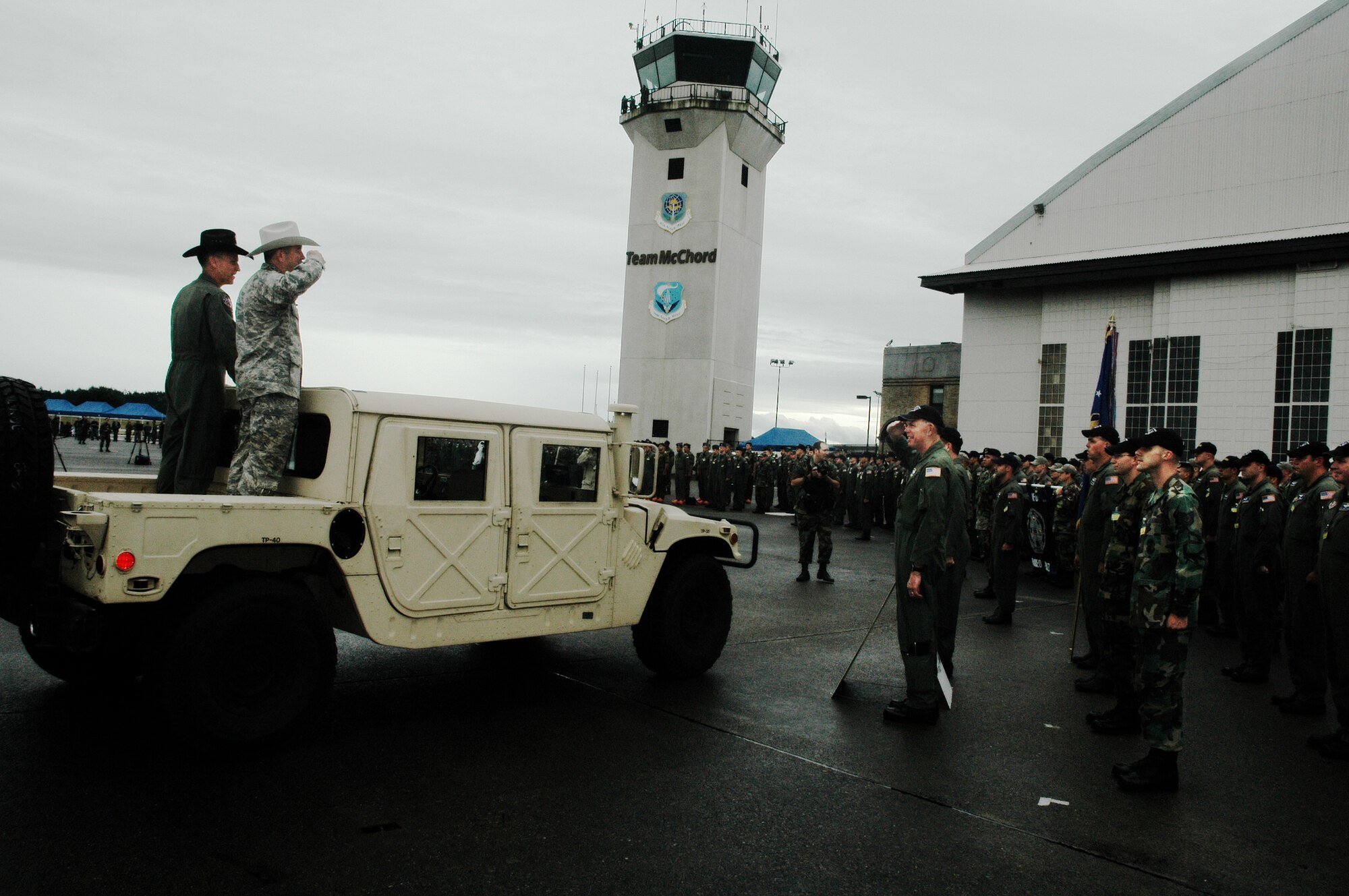 Brig. Gen. Wade Farris, 439th Airlift Wing commander, and the Patriot Wing competitors salute Gen. Duncan McNabb, commander of Air Mobility Command (wearing the Rodeo cowboy hat) during opening ceremonies at McChord, July 22. (U.S. Air Force photo / Tech Sgt. Andrew Biscoe)