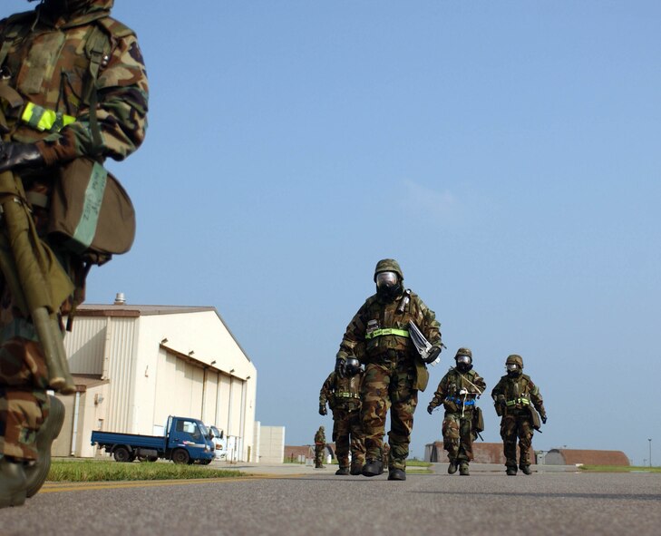 KUNSAN AIR BASE, Republic of Korea -- Airmen from the 8th Maintenance Squadron evacuate their facility on the flightline after it was demolished during a missle attack during the Peninsula-Wide Combat Employment Readiness Exercise, July 25 here. (U.S. Air Force photo/Senior Airman Steven R. Doty)                               