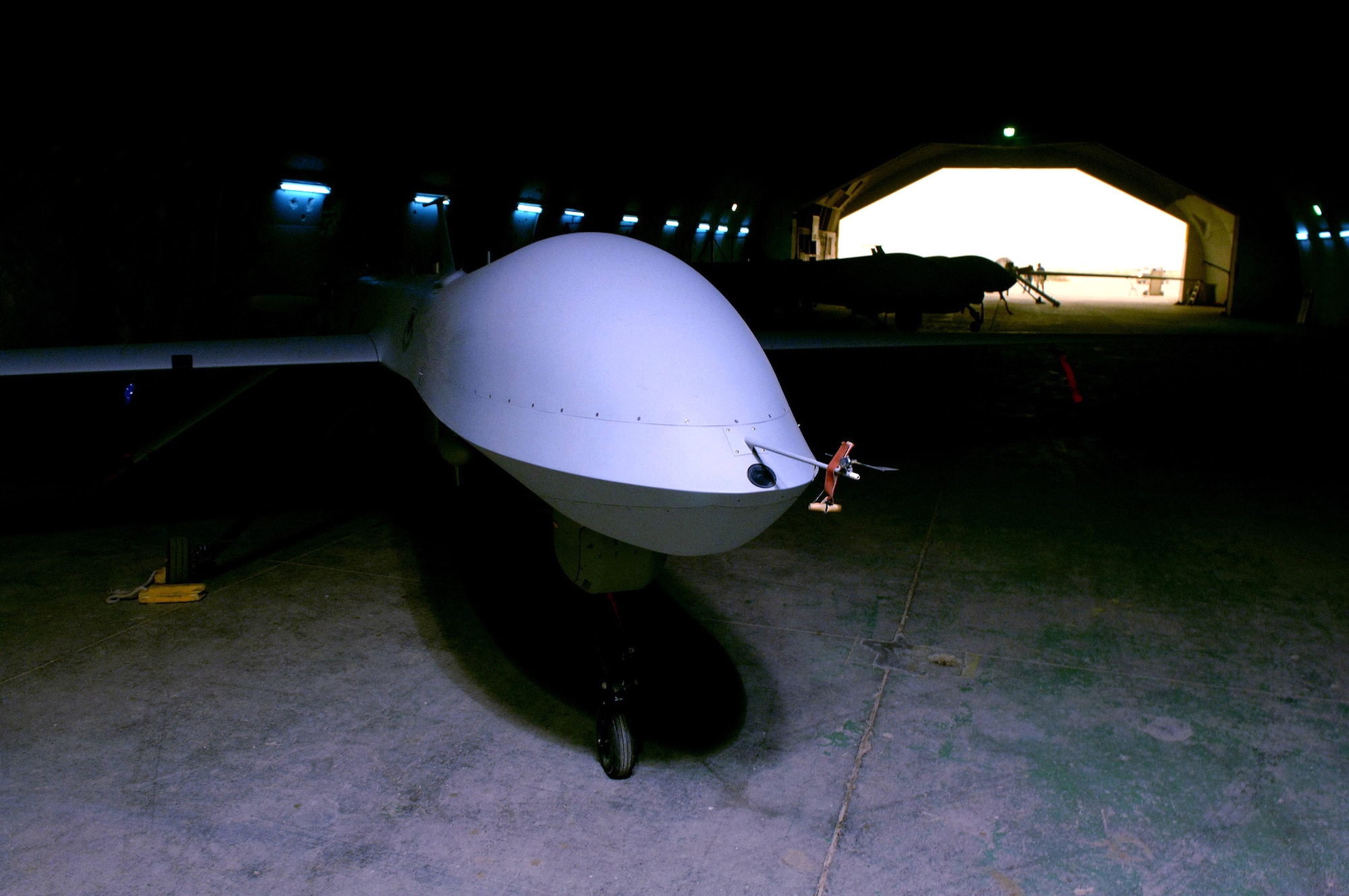 An MQ-1 Predator unmanned aerial vehicle sits in a hangar at Balad Air Base, Iraq, waiting for its next mission. Predators had a big impact in Iraq July 24, stopping an insurgent mortar team with a Hellfire missile. (U.S. Air Force photo/Airman 1st Class Jonathan Steffen)