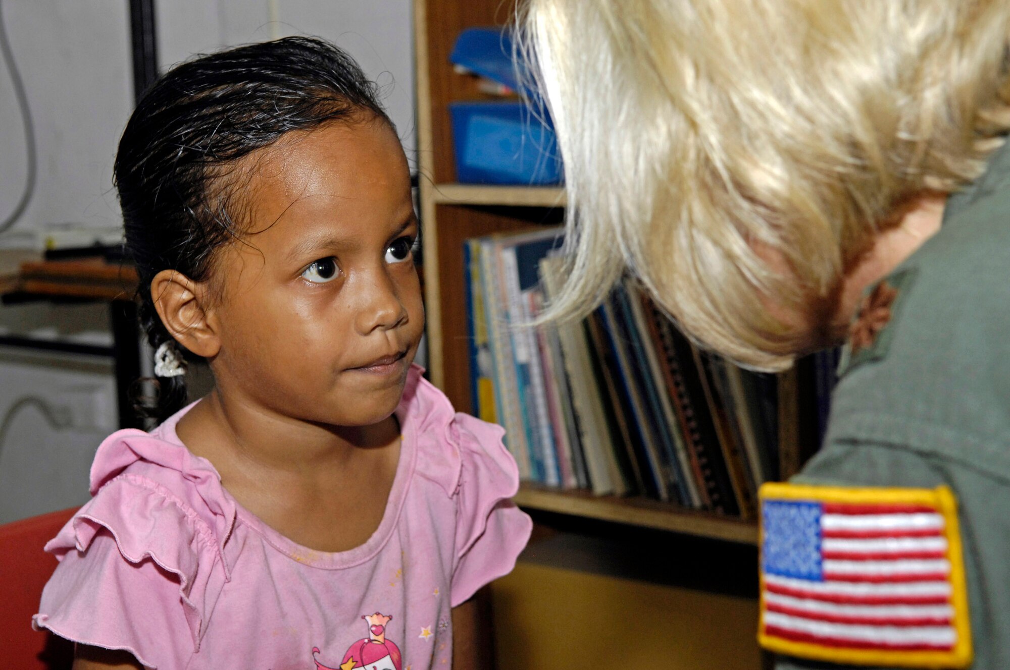 Maj. C.J. Newhouse talks with a first grader while conducting a basic hearing test July 21 on the island of Nauru. Major Newhouse is part of a 12-person, joint-force U.S. Pacific Command team deployed to Nauru to provide medical training and assistance to the island's medical professionals. Major Newhouse is a Reserve flight nurse with the 446th Aeromedical Evacuation Squadron from McChord Air Force Base, Wash. (U.S. Air Force photo/Tech. Sgt. Chris Vadnais)
