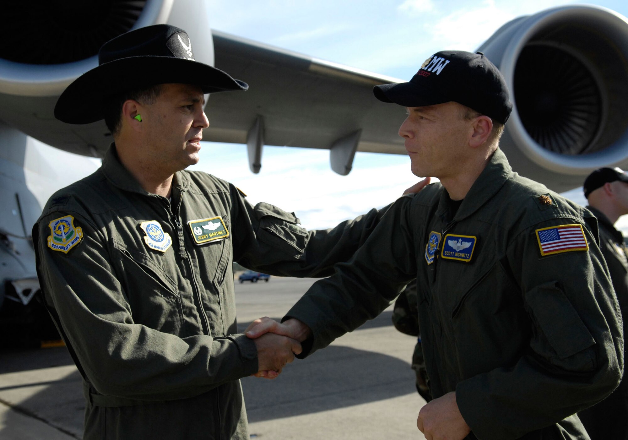 Col. Jerry Martinez, 62nd Airlift Wing commander, McChord Air Force Base, Wash., shakes hands with Maj. Scott Nishwitz, 60th Air Mobility Wing, July 21. Rodeo 2007, hosted by Air Mobility Command, is a readiness competition of U.S. and international mobility air forces. It focuses on improving warfighting capabilities and support of the Global War on Terrorism. (U.S. Air Force photo/Airman 1st Class Bryan Boyette)