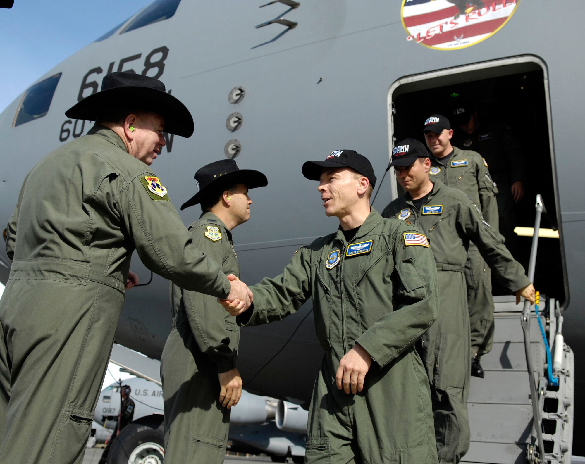 Col. Jerry Martinez, 62nd Airlift Wing commander, greets members of the 60th Air Mobility Wing July 21. Rodeo 2007, hosted by Air Mobility Command and held at McChord Air Force Base, Wash., is a readiness competition of U.S. and international mobility air forces. It focuses on improving warfighting capabilities and support of the Global War on Terrorism. (U.S. Air Force photo/Airman 1st Class Bryan Boyette)