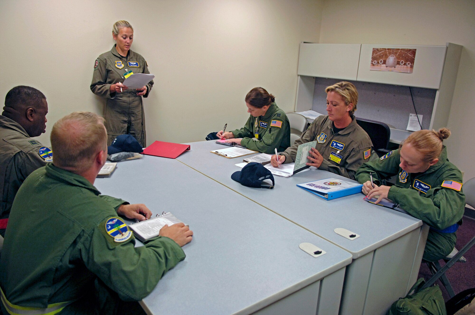 Lt. Col. Tami Rougeau, an Air Mobility Rodeo 2007 evaluator, briefs the aeromedical evacuation configuration scenario to the 315th Aeromedical Evacuation Squadron team from Charleston Air Force Base, S.C., at McChord Air Force Base, Wash., July 23.  Air Mobility Command's Rodeo 2007 is a readiness competition of U.S. and international mobility air forces.  It focuses on improving warfighting capabilities and support of the Global War on Terrorism.  (U.S. Air Force Photo/Tech. Sgt. Maria J. Bare)