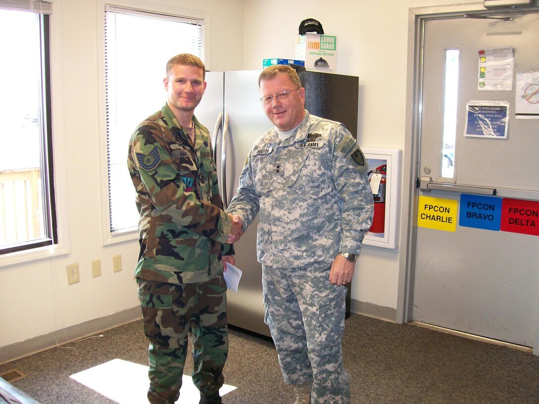 U.S. Army MG Larry Shellito, Adjutant General for the Minnesota National Guard, shakes the hand of newly-promoted U.S. Air Force Technical Sgt. Bryce Hanson at the 148th Fighter Wing alert facility at Shaw AFB, S.C., July 19, 2007.  (USAF photo/Capt. Audra Flanagan)