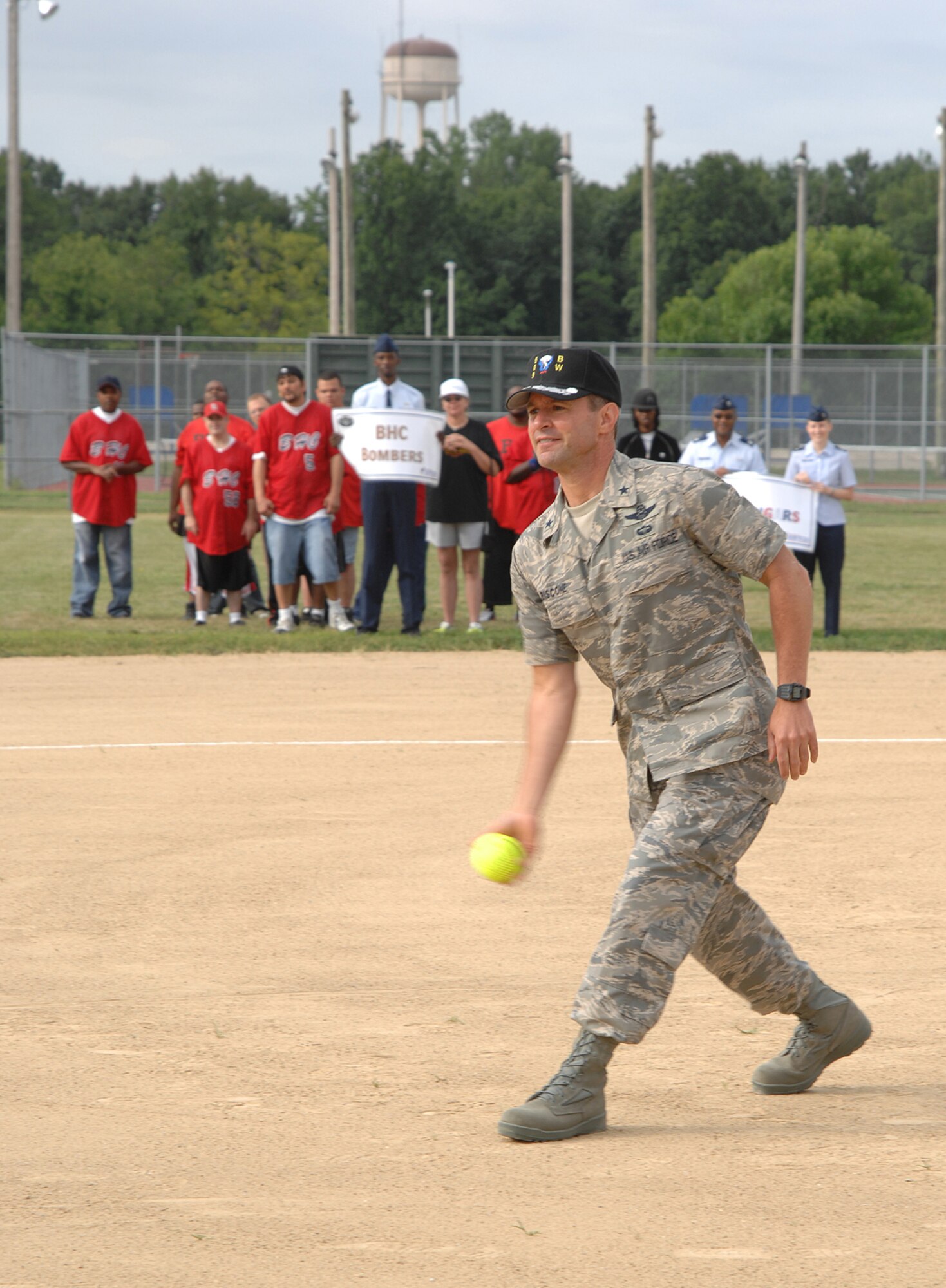 WHITEMAN AIR FORCE BASE, Mo. -- Brig. Gen. Greg Biscone, 509th Bomb Wing commander, throws out the opening pitch to begin the Missouri Central Area Special Olympics softball tournament here July 20 and 21. More than 130 Special Olympians from surrounding areas participated in the tournament and more than 200 volunteers from Whiteman helped sponsor teams and participated in field maintenance, scorekeeping, umpiring and cheering for the athletes. This was the 17th year Whiteman has hosted the Special Olympics tournament. “I’ve enjoyed working the coordination between Whiteman and Special Olympics for the past four years,” said Tech. Sgt. Don Ware, 509th Services Squadron and Special Olympics volunteer. “It’s been a joy to see the looks on the athletes faces when they come to here and see the support that the squadrons provide for them.”  (U.S. Air Force photo/Senior Airman Lauren Padden)