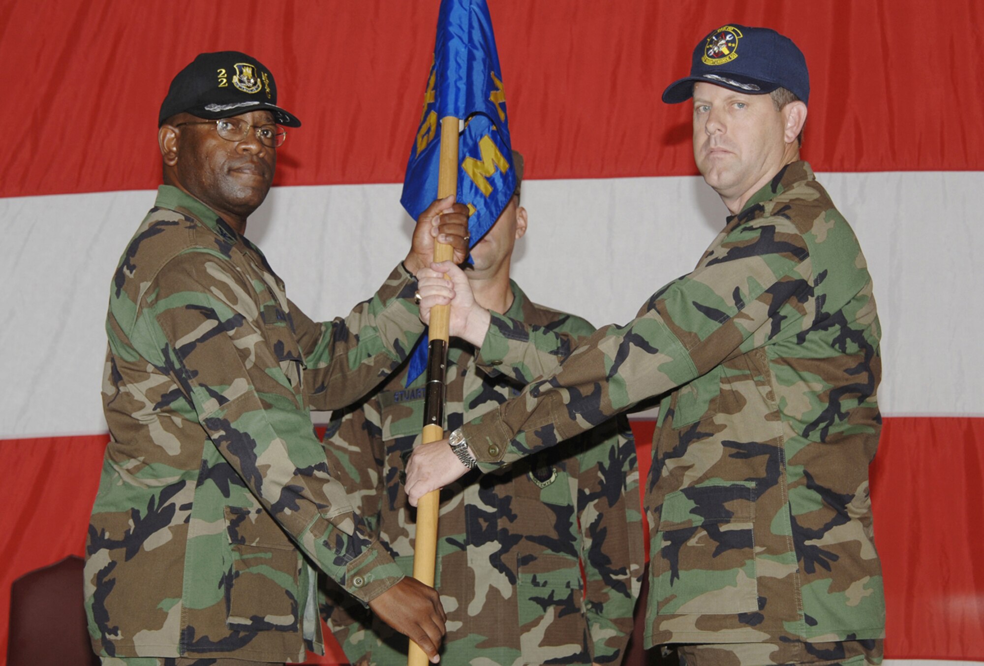 MCCONNELL AIR FORCE BASE, Kan. -- Col. Michael Dillard, left, 22nd Maintenance Group commander, hands the 22nd Maintenance Squadron guidon and command of the squadron to Lt. Col. John Martin July 20 during a change of command ceremony here. (Photo by Airman 1st Class Jessica Corob)