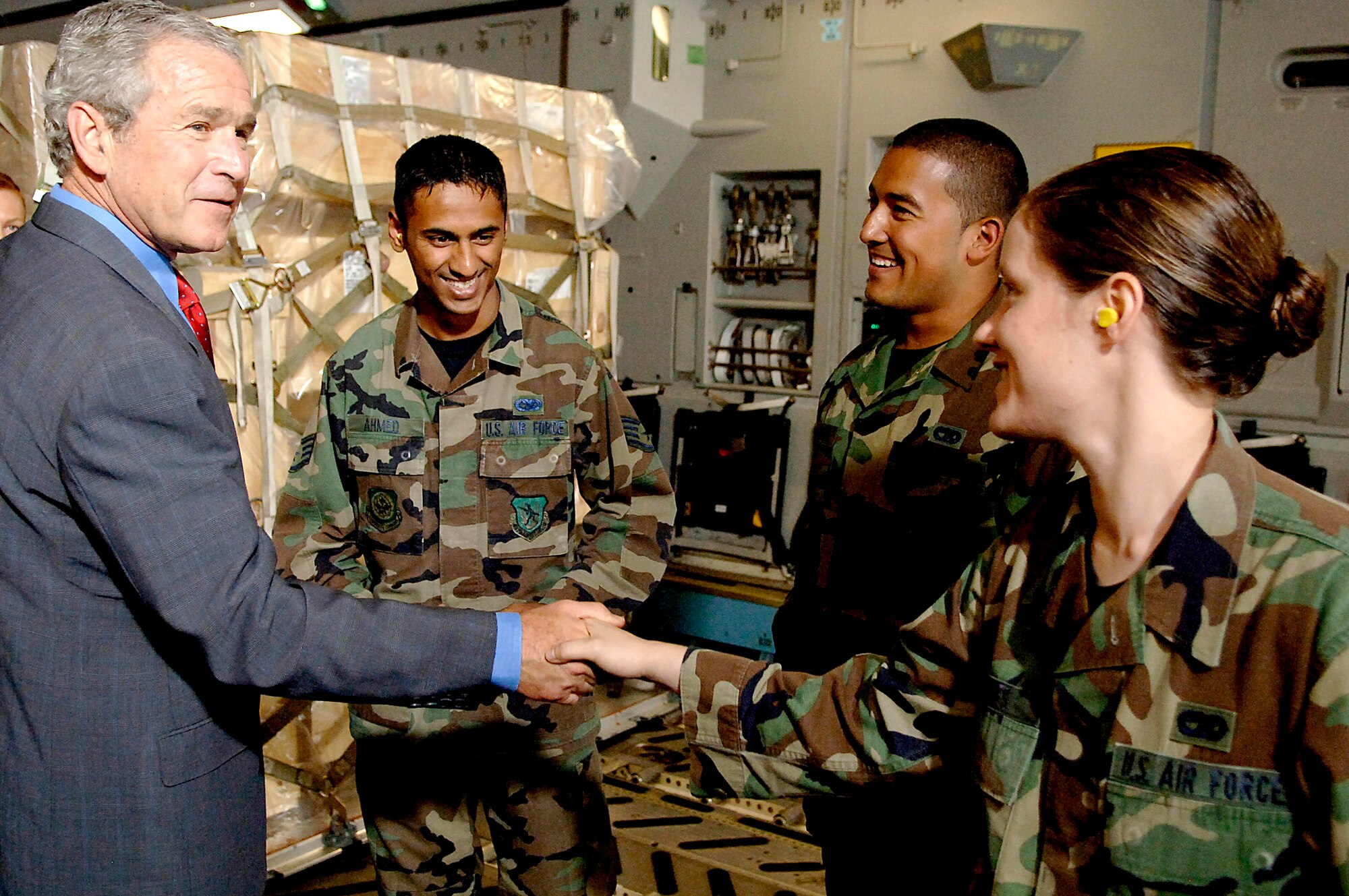 President George W. Bush shakes hands with Senior Airman Shannon Jones in a C-17 Globemaster III July 24 on the Charleston Air Force Base flightline in South Carolina. President Bush visited Charleston AFB, took a tour of a static C-17 Globemaster III, ate lunch with Airmen from the base and talked about the war on terrorism. Airman Jones is a 437th Aerial Port Squadron cargo processor. (U.S. Air Force photo/Airman 1st Class Nicholas Pilch) 