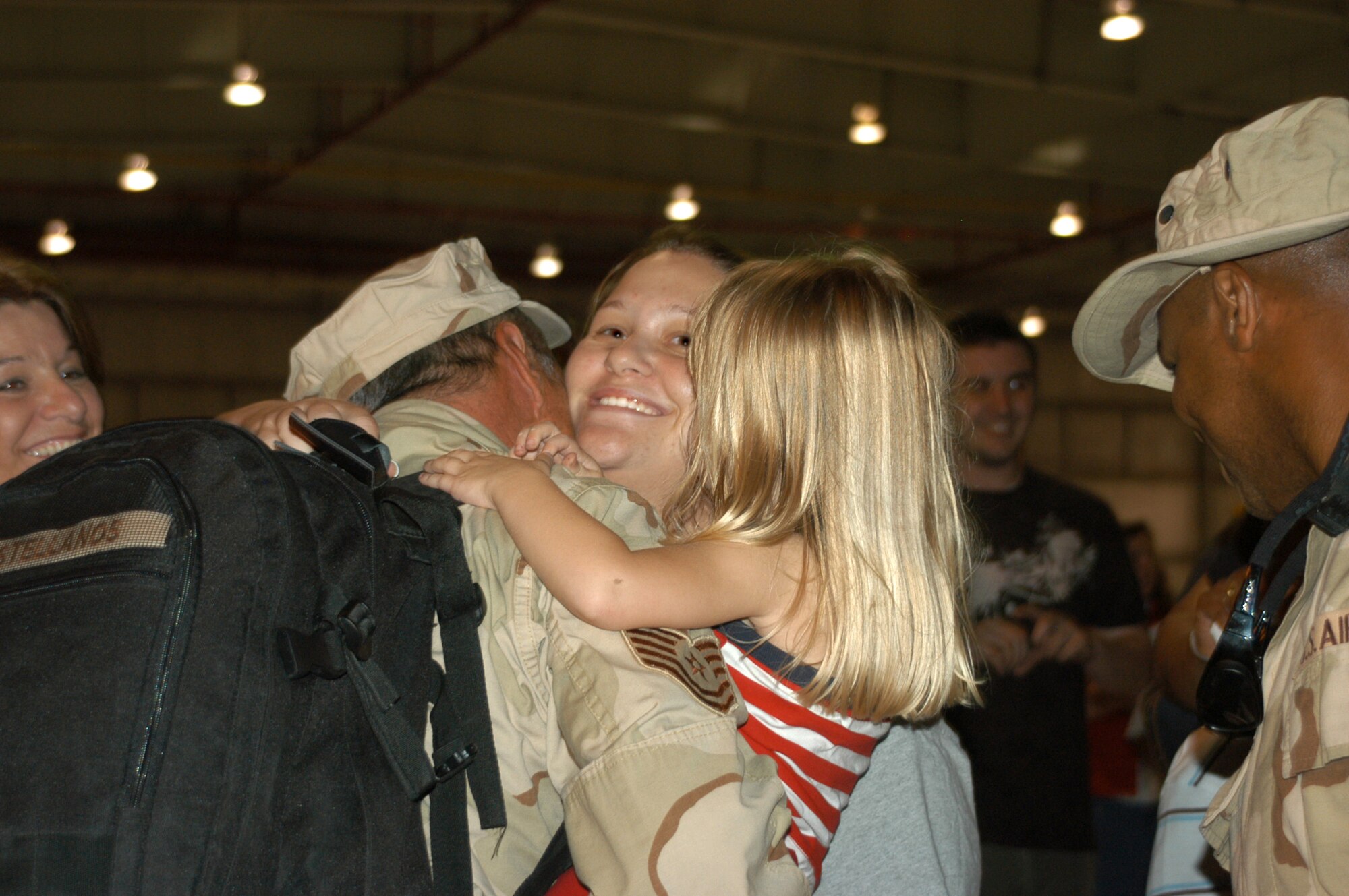 Tech. Sgt. Jose Castellanos, Sr., 301st Aircraft Maintenance Squadron aircraft weapons systems technician, receives lots of hugs after a deployment to Balad Air Base, Iraq. Nearly 200 Air Force Reservists from the 301st Fighter Wing out of the Naval Air Station Joint Reserve Base Fort Worth, Texas, deployed in support of Operation Iraqi Freedom recently. (U.S. Air Force Photo/Tech. Sgt. Julie Briden-Garcia)